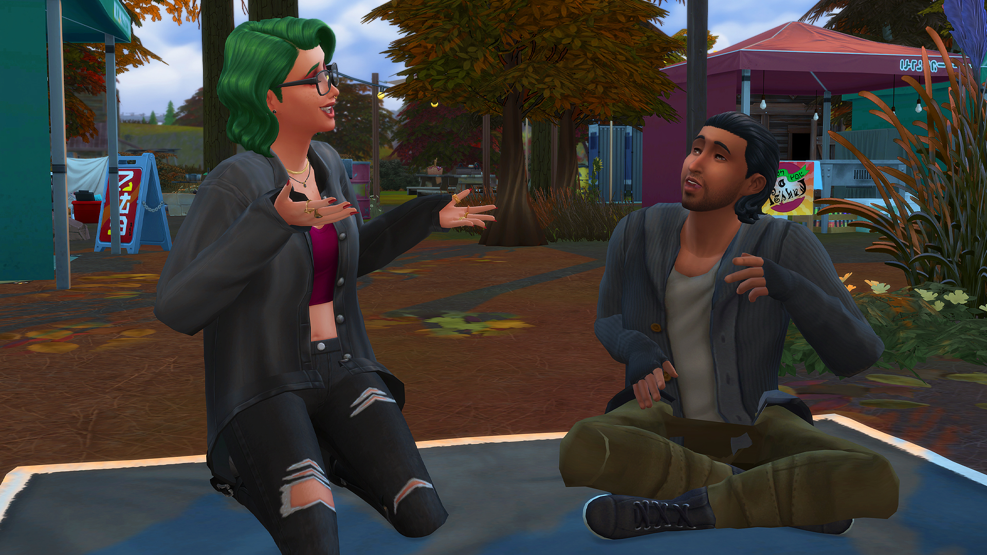 Two Sims talking and sitting on a blanket outside in The Sims 4
