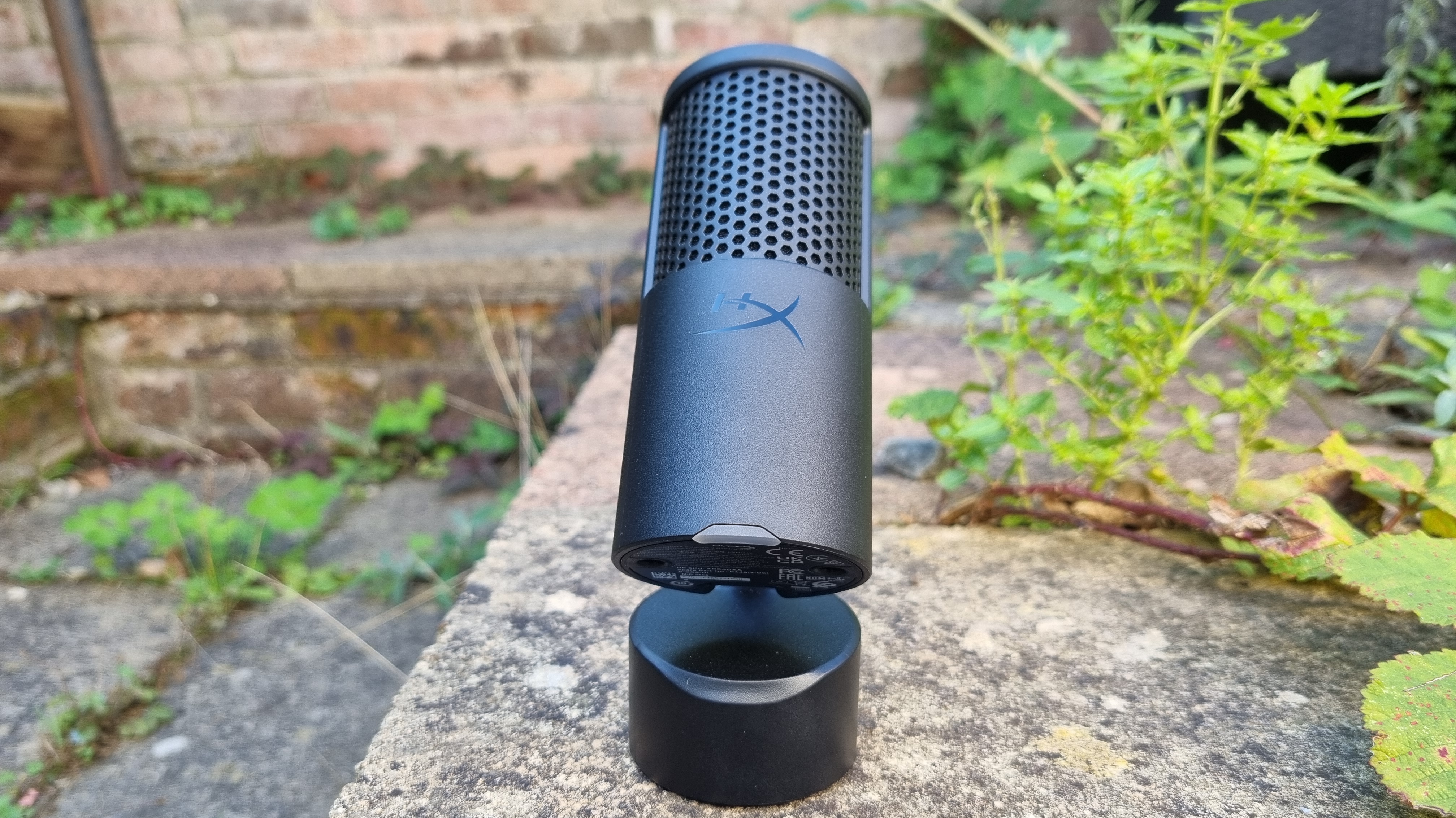 The HyperX Solocast 2 USB microphone shot from the front, with its stand deployed