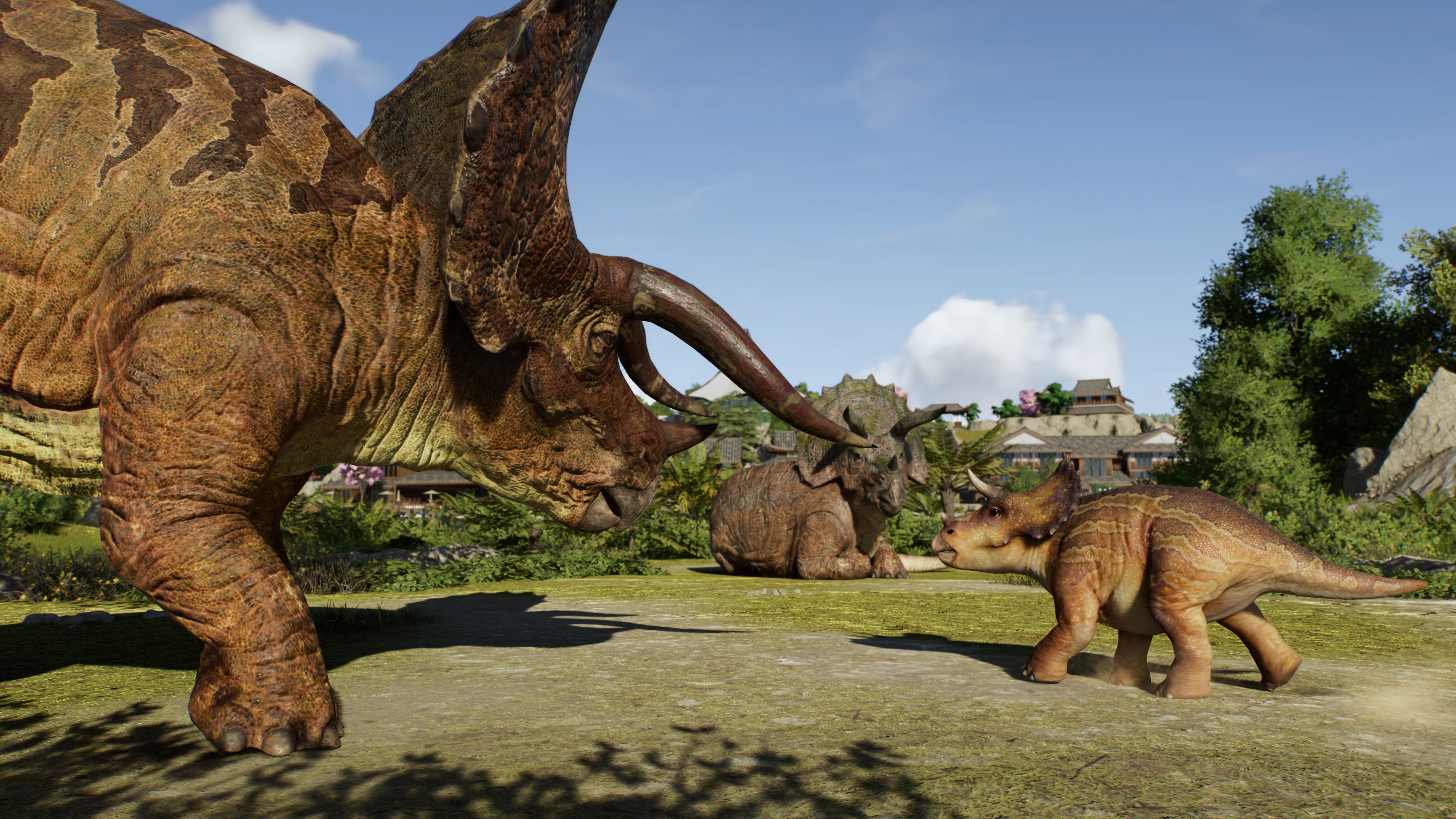 A triceratops with its baby in Jurassic World Evolution 3.