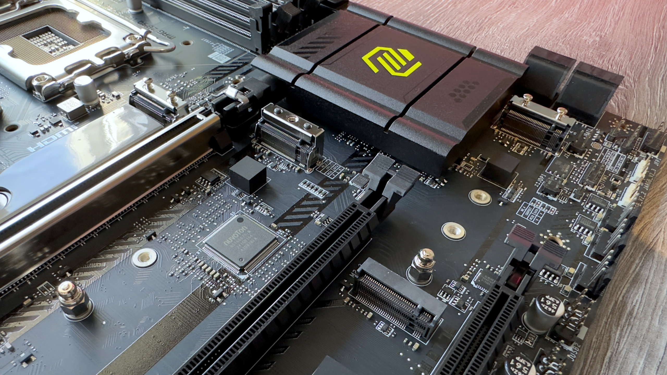 A close-up photo of the MSI MAG Z890 Tomahawk WiFi motherboard, showing its M.2 slots without heatsinks.
