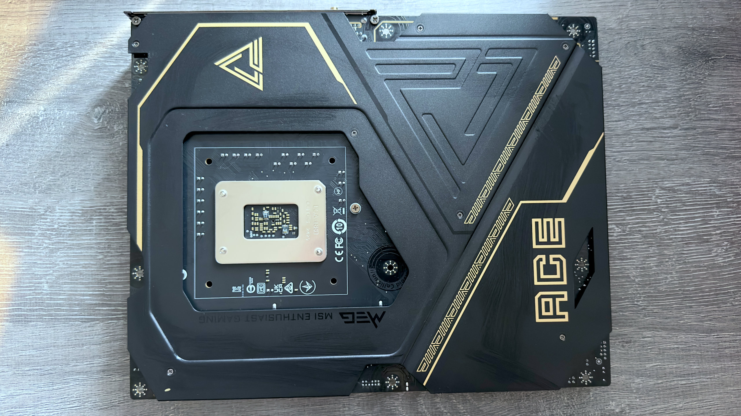 A photo of the rear side of the MSI MEG Z890 Ace motherboard.