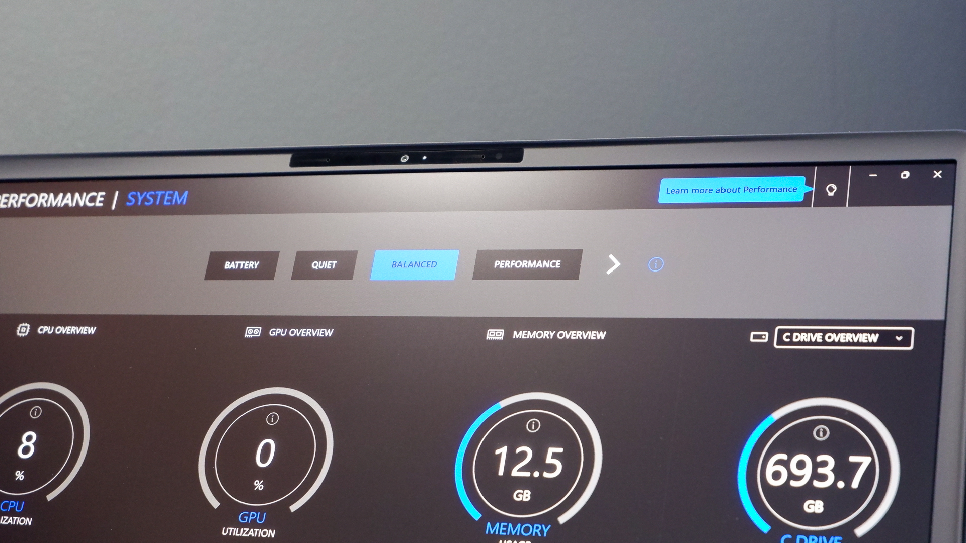 An Alienware 16 Area-51 gaming laptop with RGB lighting in blue on a desk mat.