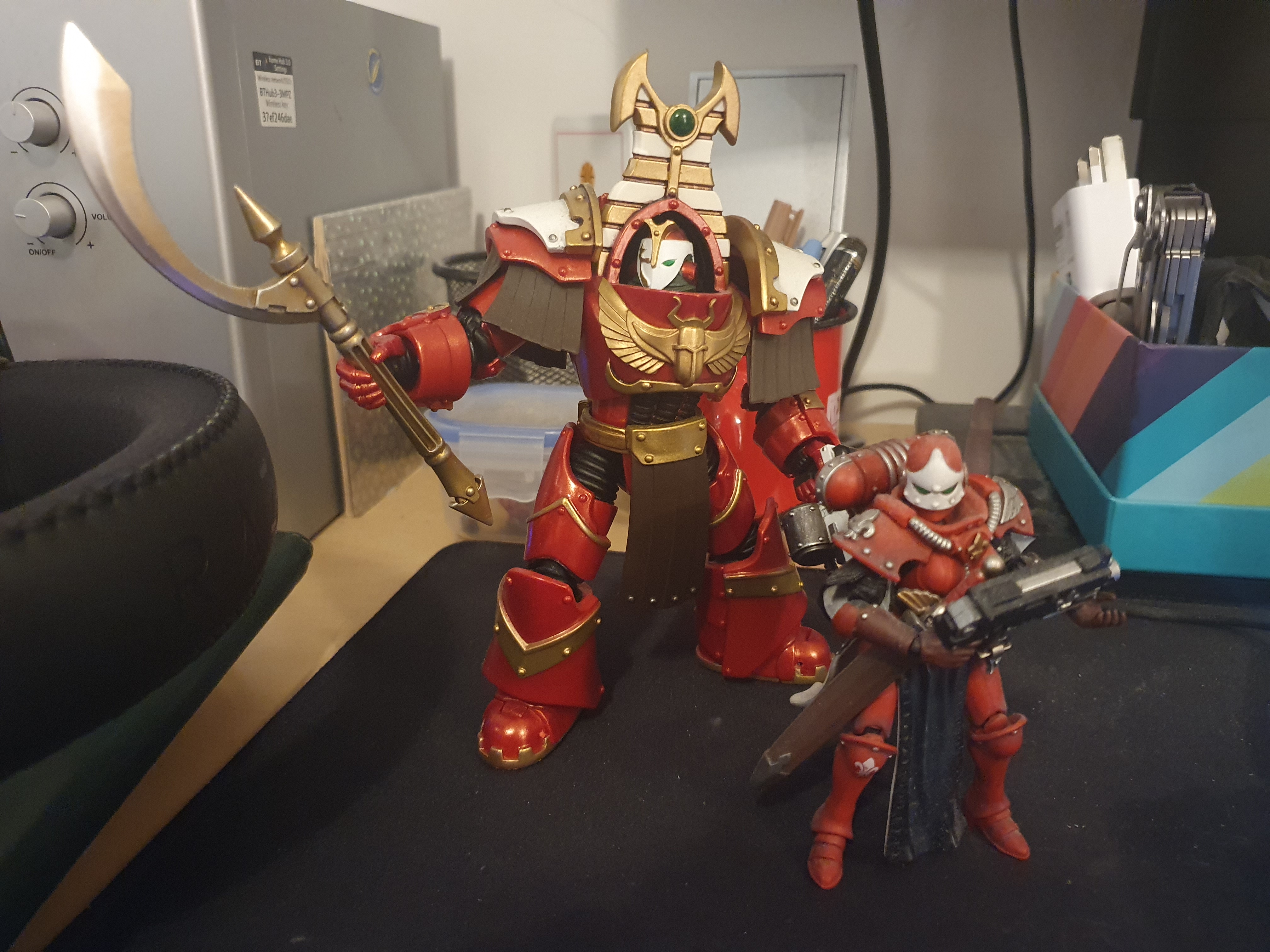 Two action figures - a Thousand Sons terminator, and a Sister of Battle.