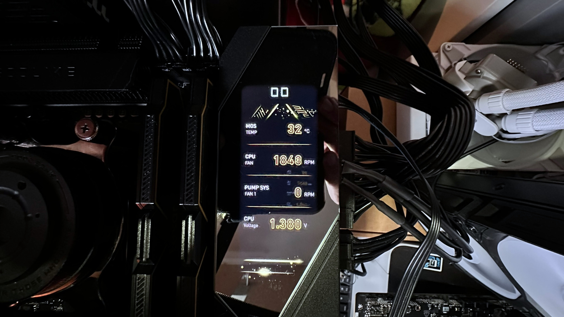 A dark photo showing the Digital Dashboard III panel on an MSI MEG X870E Godlike X Edition motherboard