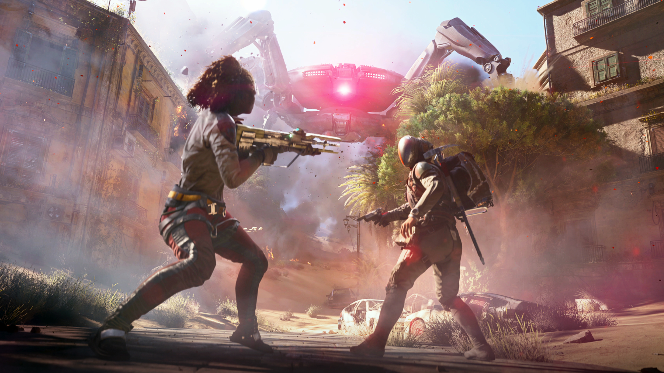 Arc Raiders: Key art featuring two raiders holding weapons and standing in the middle of the road, turning to run away from a large Queen spider-like robot on the buildings in the background.
