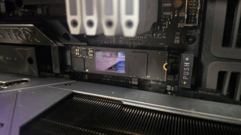 A WD Blue SN5100 ready to be installed inside a gaming PC.