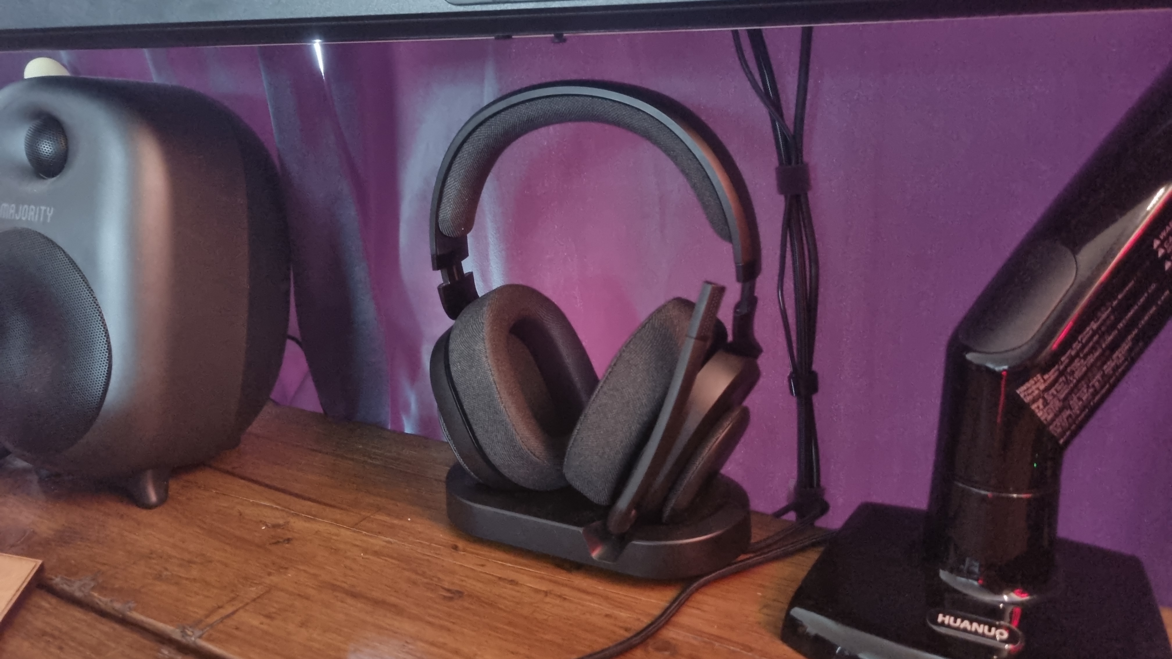 The Fractal Design Scape gaming headset atop its stand, on a desk