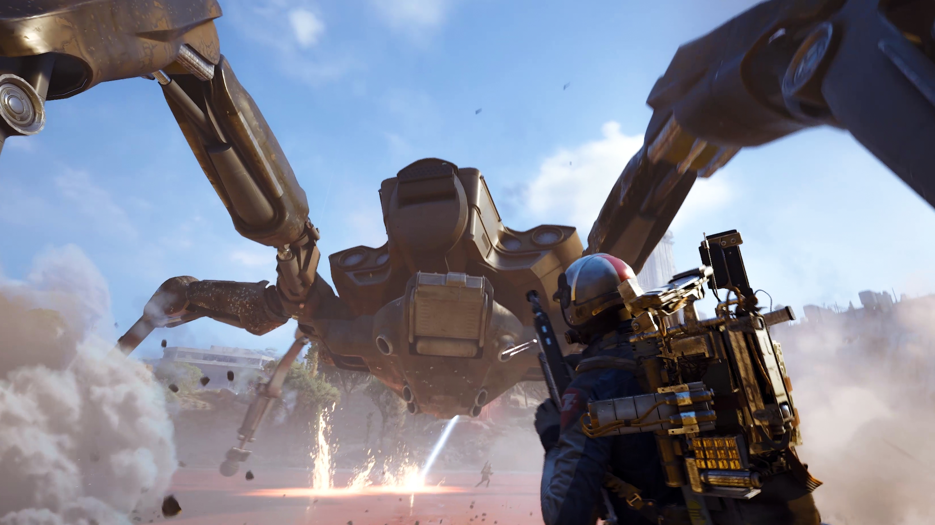 Arc Raiders Queen blaze grenade traps: A player reloading their gun while fighting a Queen at the base of the dam wall in Dam Battlegrounds, as it kicks up sand and fires a laser at another player in the distance.