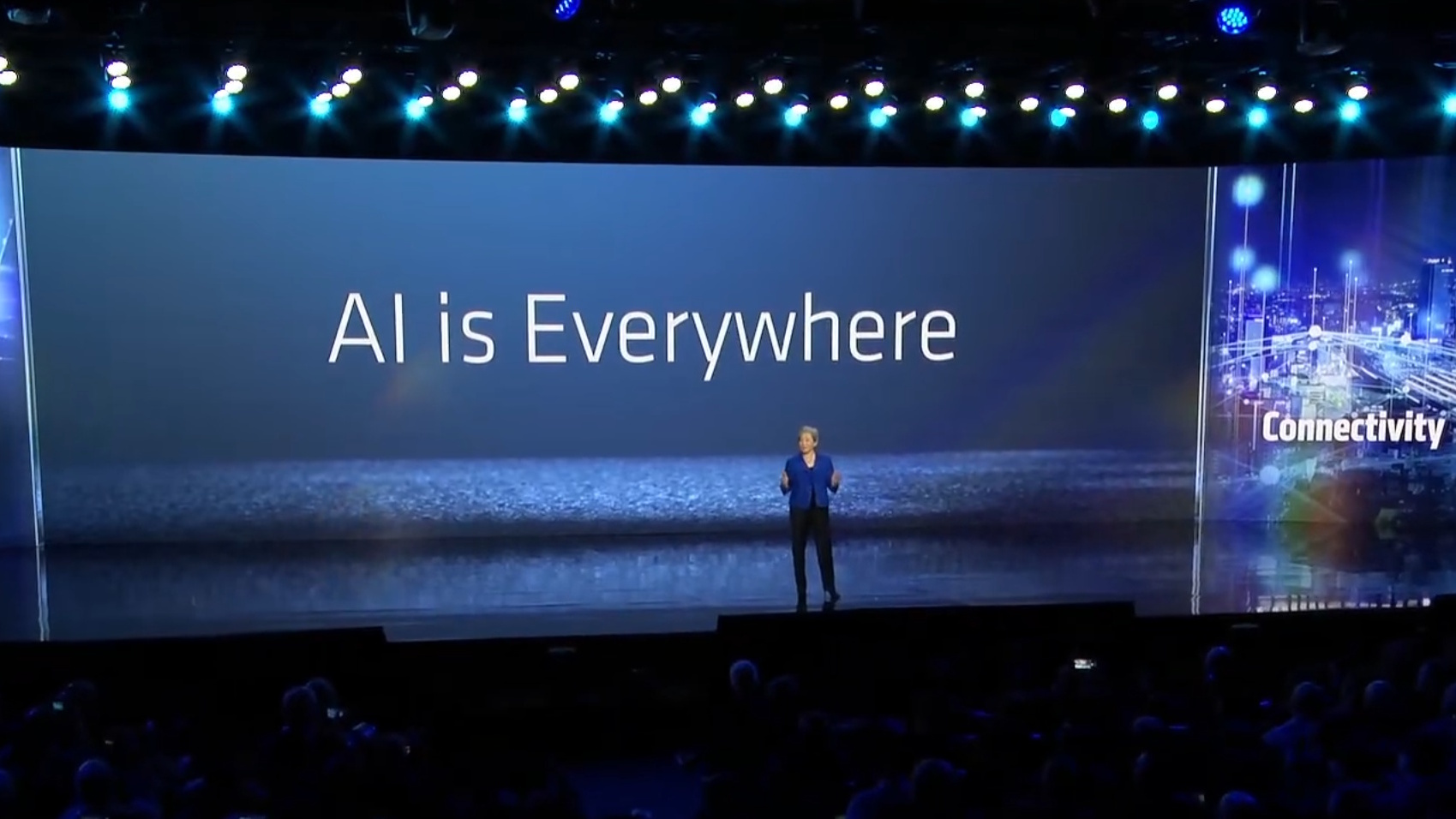 AMD CEO Dr. Lisa Su on stage with 'AI is everywhere' in the background.