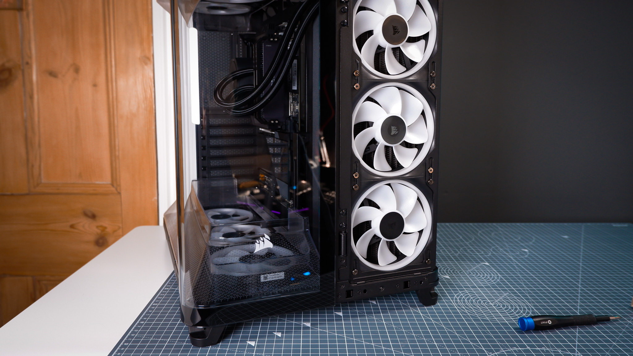 A Corsair Air 5400 PC case on a desk with various parts installed.