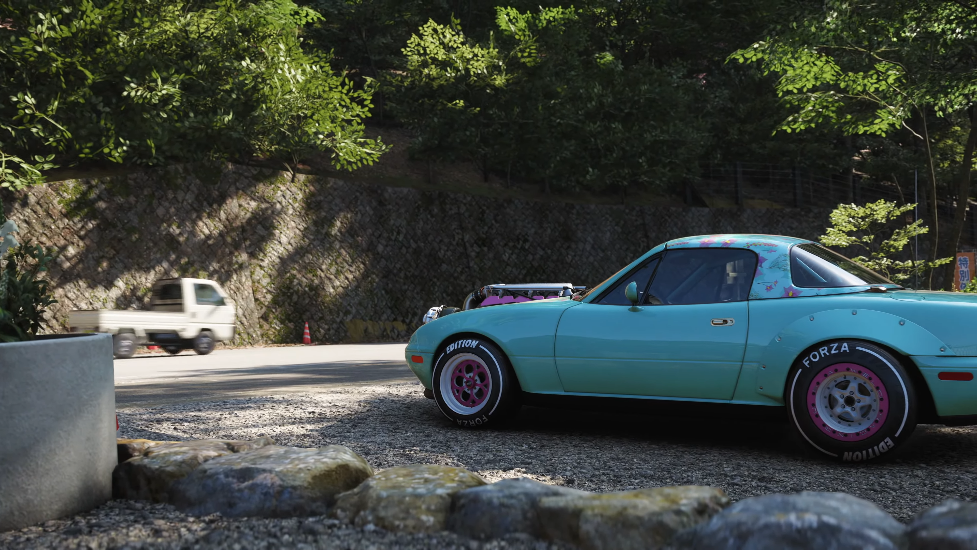 An aftermarket car in Forza Horizon 6, with a kei truck driving by on a road in the background.