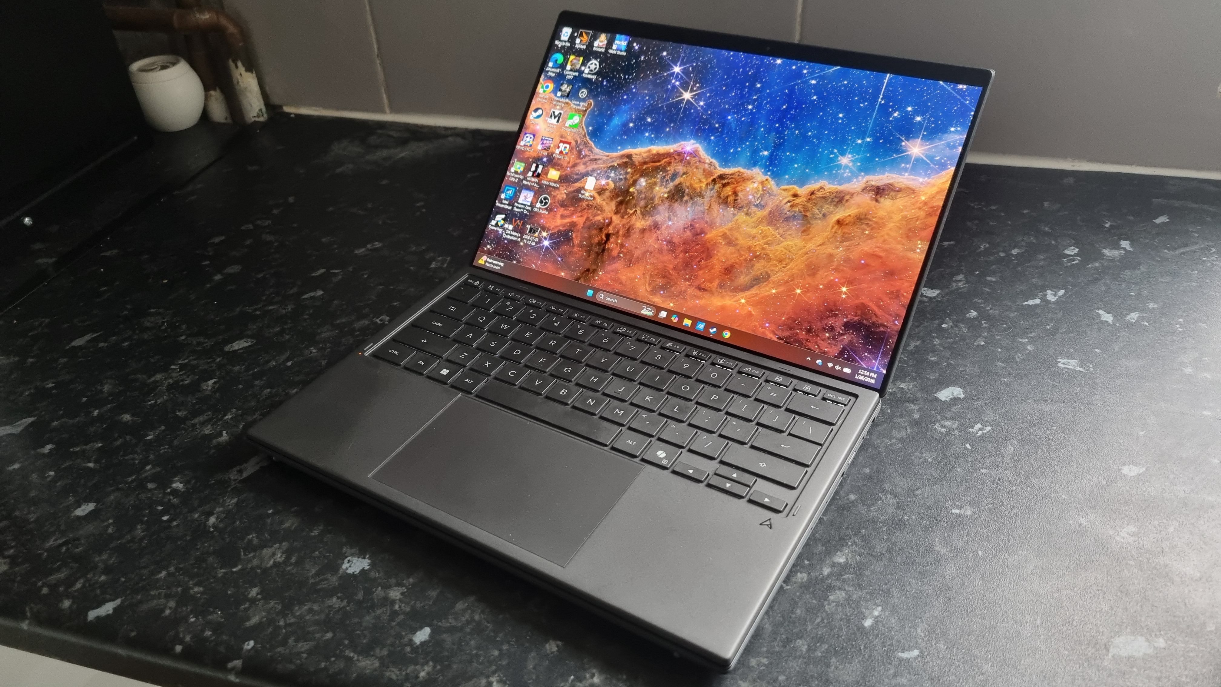 An Asus Zenbook Duo laptop on a kitchen counter