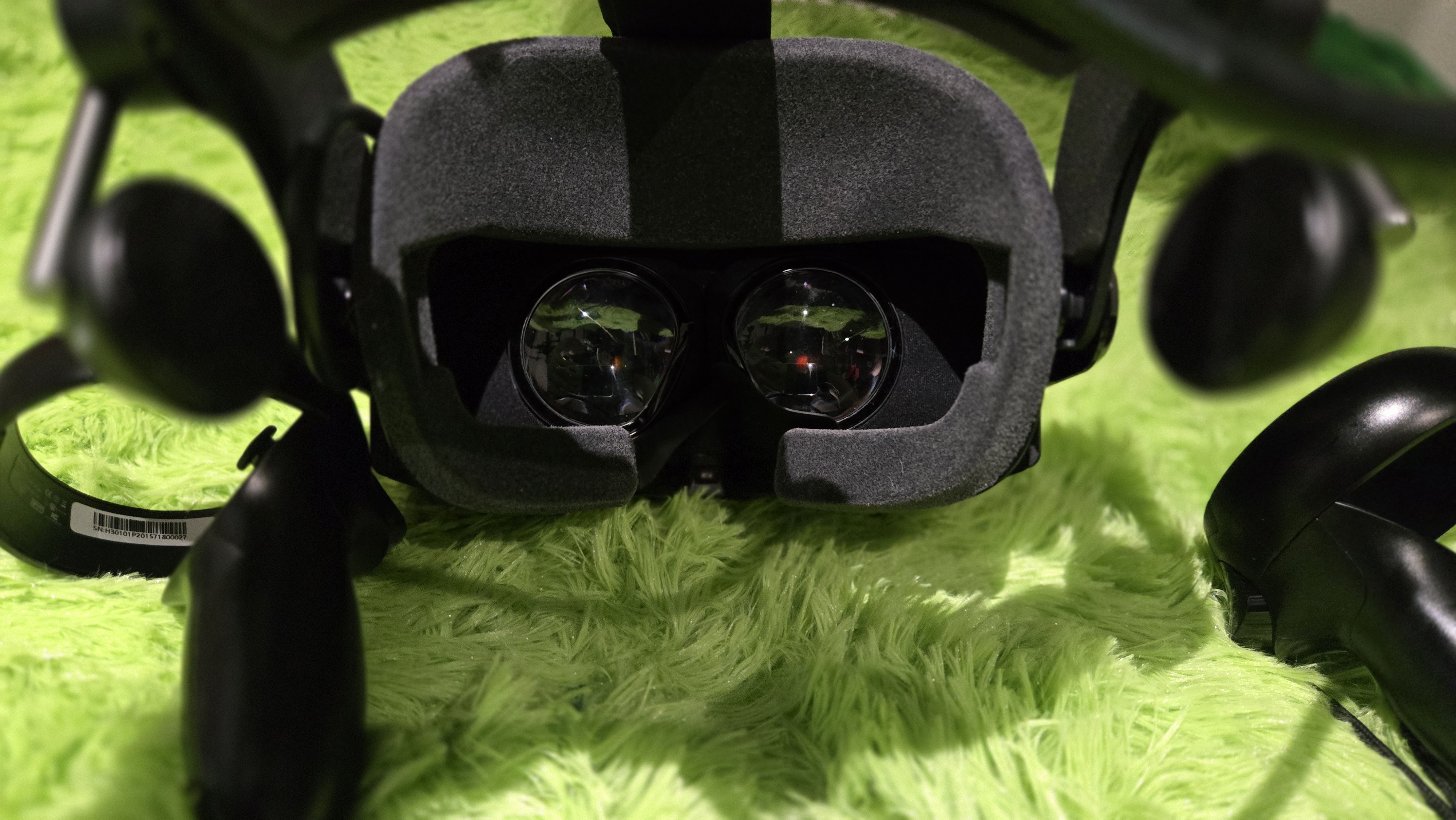 A Pimax Crystal Super virtual reality headset on a green background.