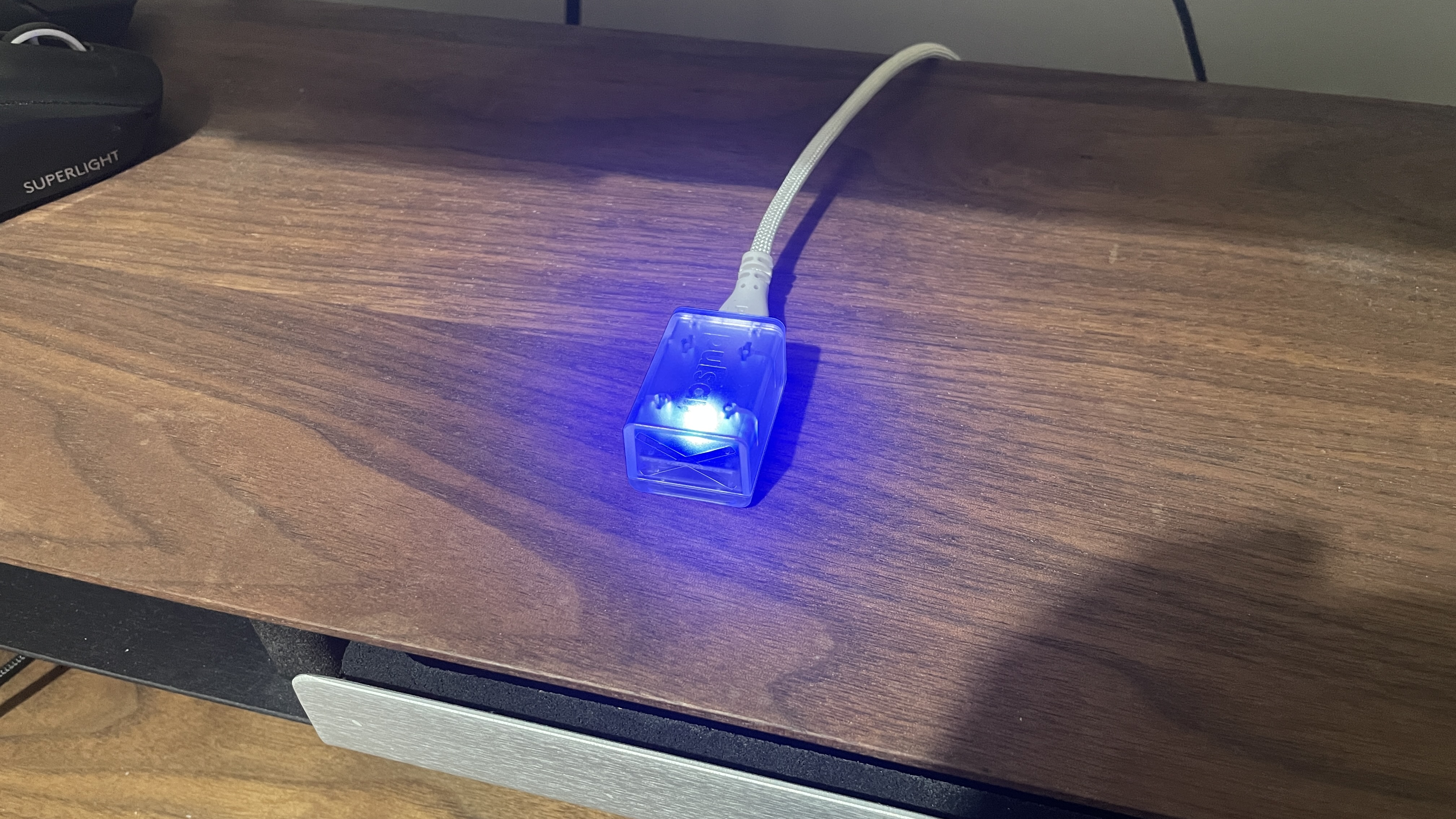 A Pulsar X2 CrazyLight Medium gaming mouse on a desk.