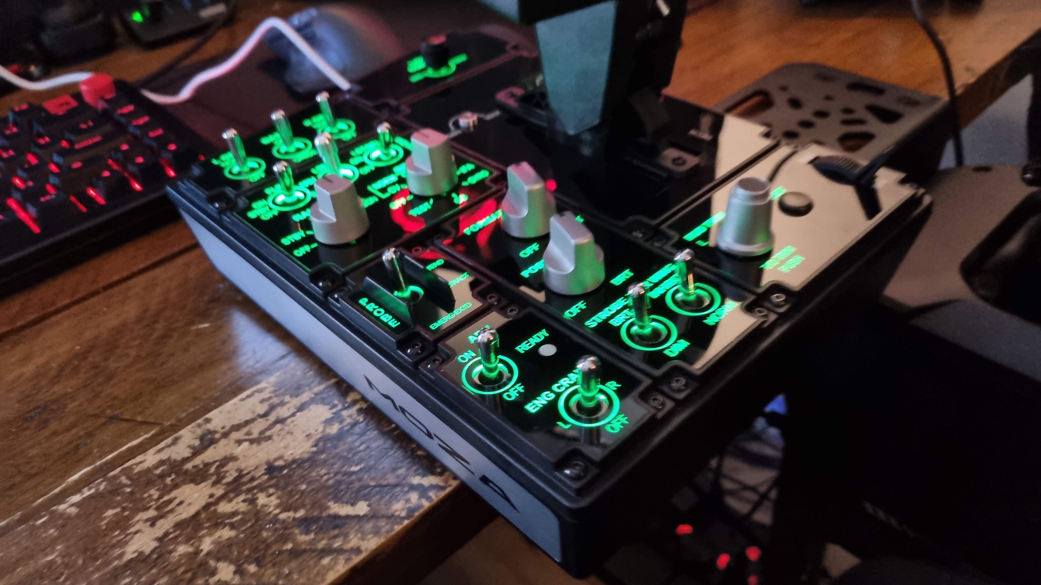 The various controls of the Moza MTP Throttle flight sim controller, lit up in green