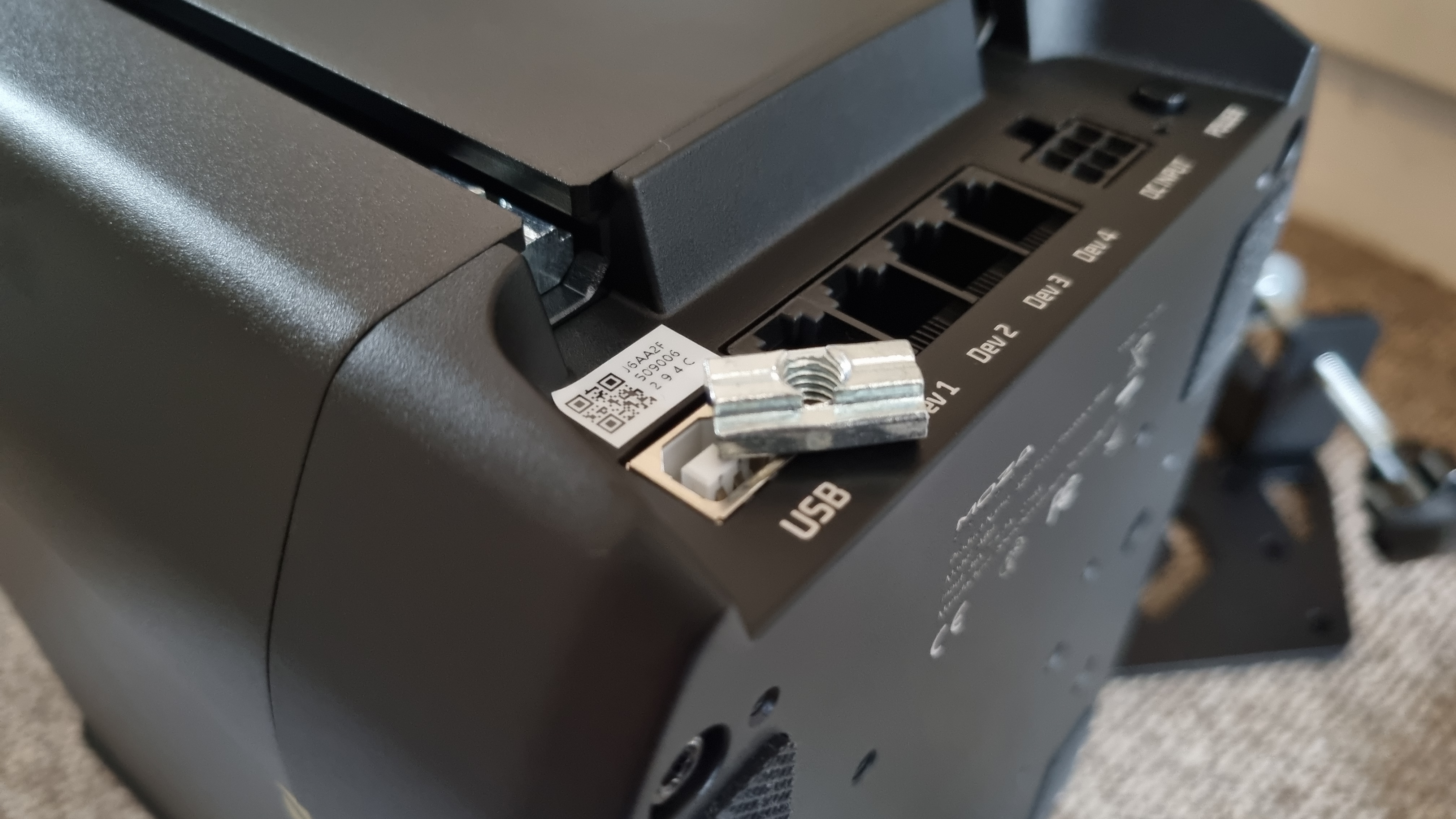 The rear connection ports of the Moza AB9 FFB Base, with a small metal insert for mounting