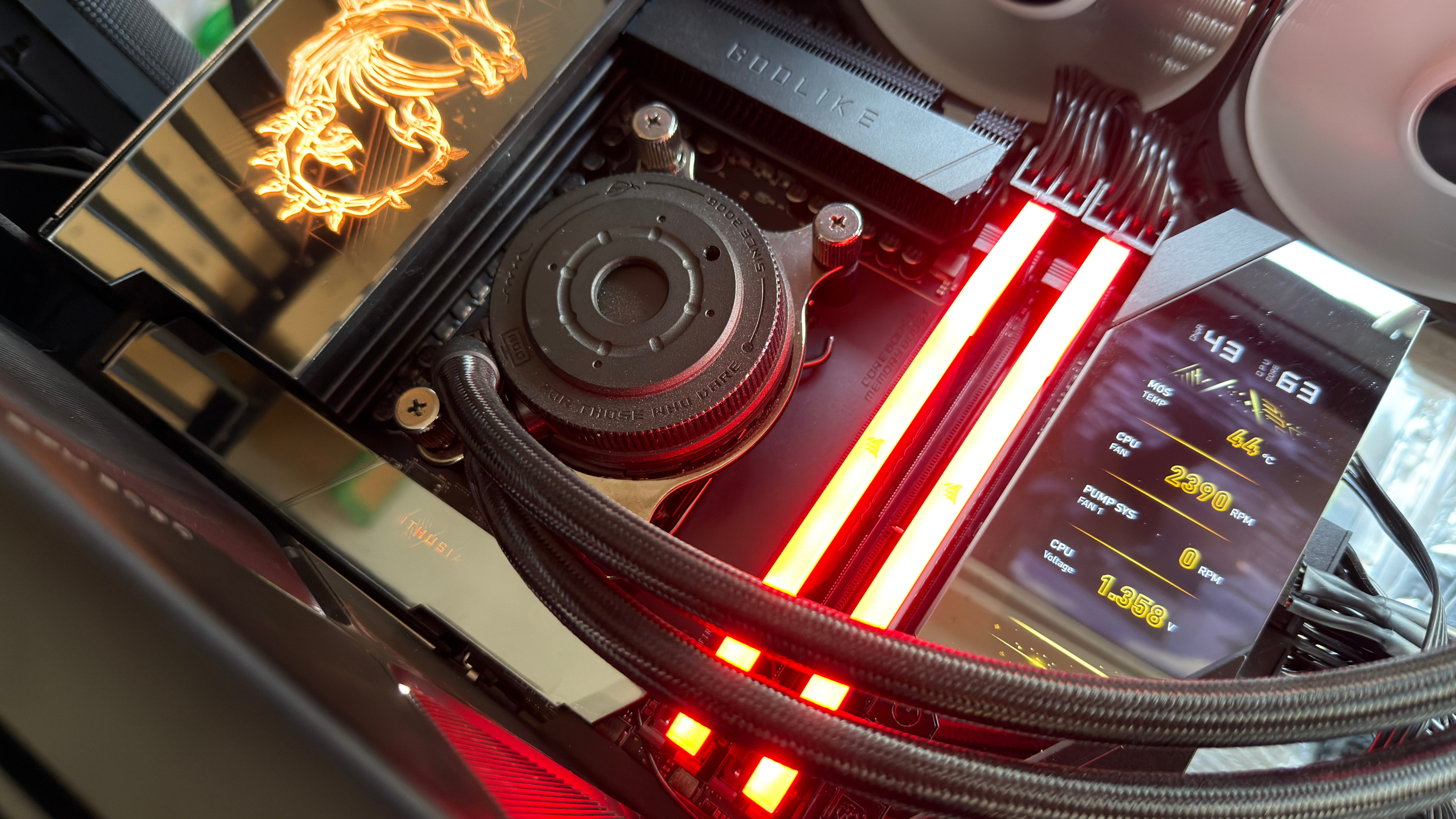 A photo of an open-case gaming PC, showing a high-end MSI motherboard, with an Asus AIO cooler, and a set of Corsair DDR5 memory