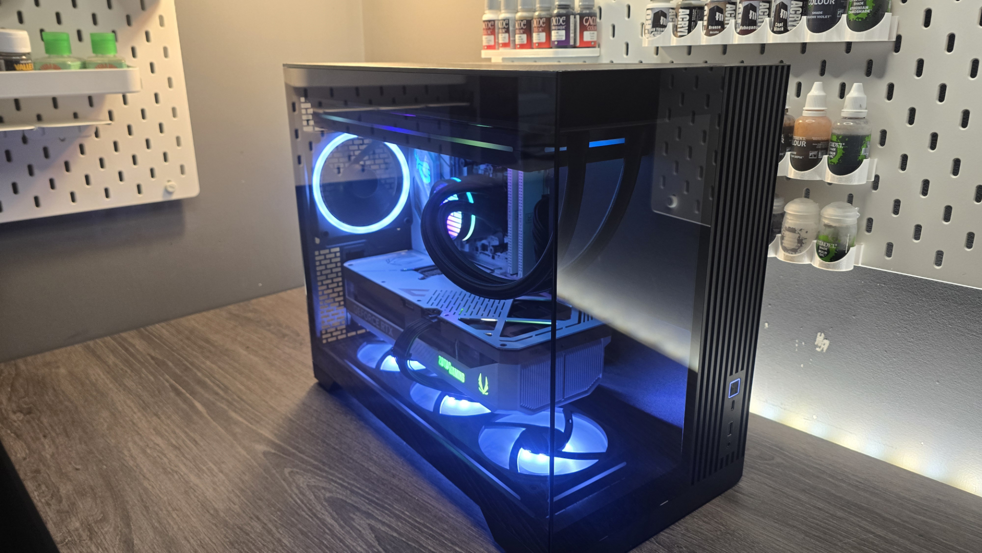 A Phanteks XT V3 PC case on a desk with various PC parts.