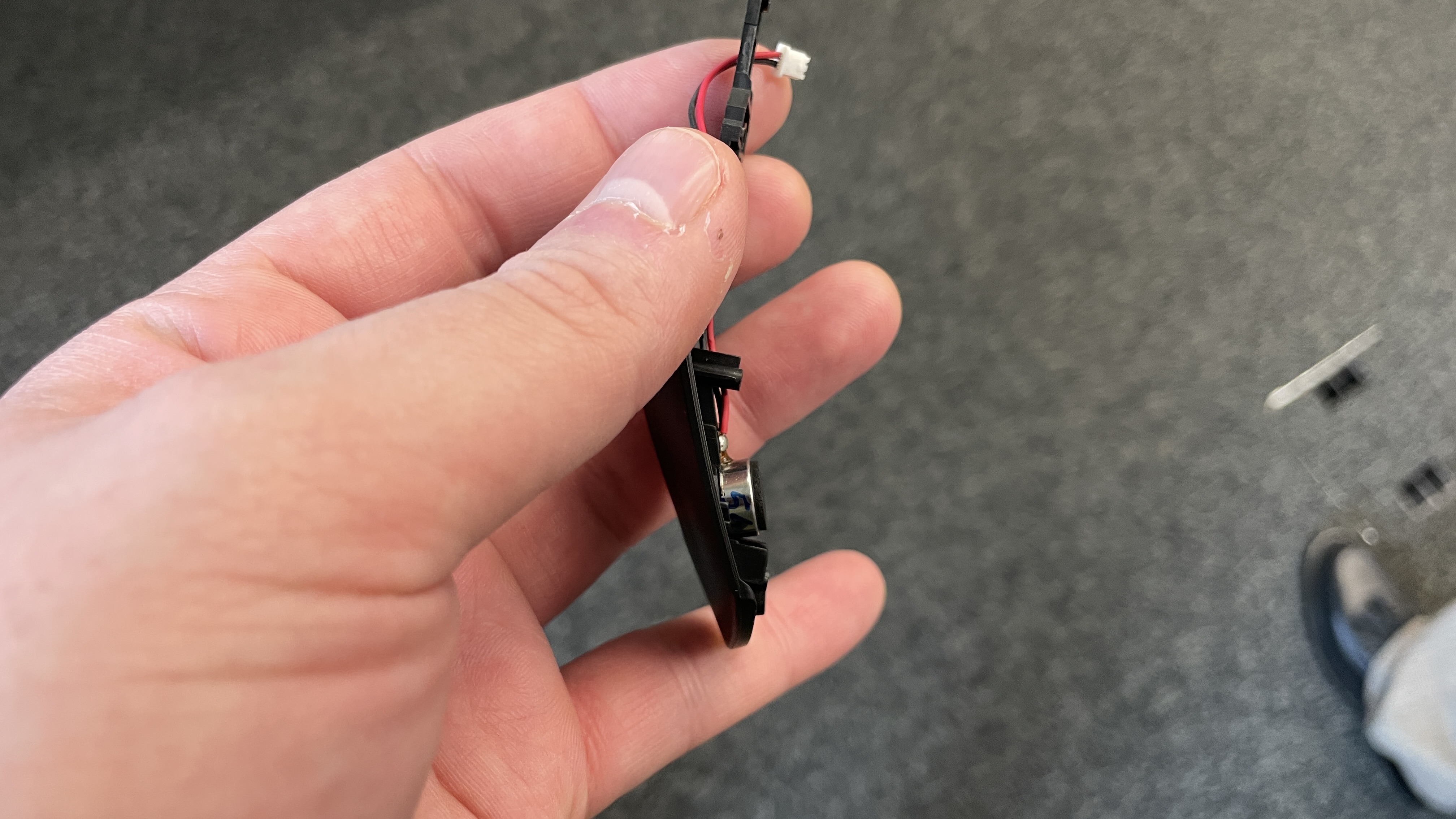 A side view of the haptic motor underneath the key plate of a Logitech G Pro X2 Superstrike gaming mouse.