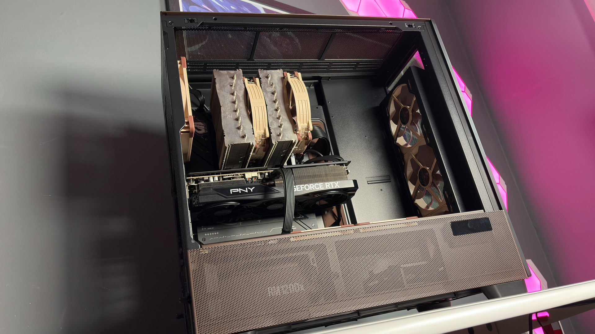 The Antec Flux Pro Noctua Edition on a desk with various parts disassembled.