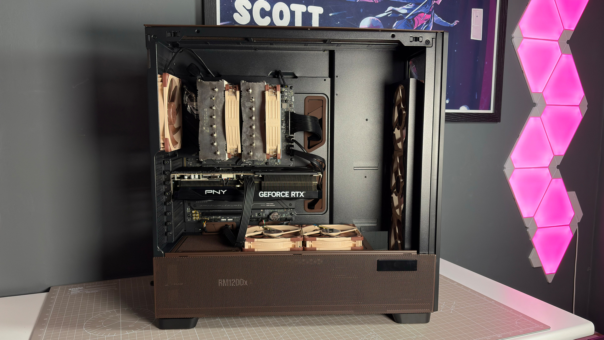 The Antec Flux Pro Noctua Edition on a desk with various parts disassembled.