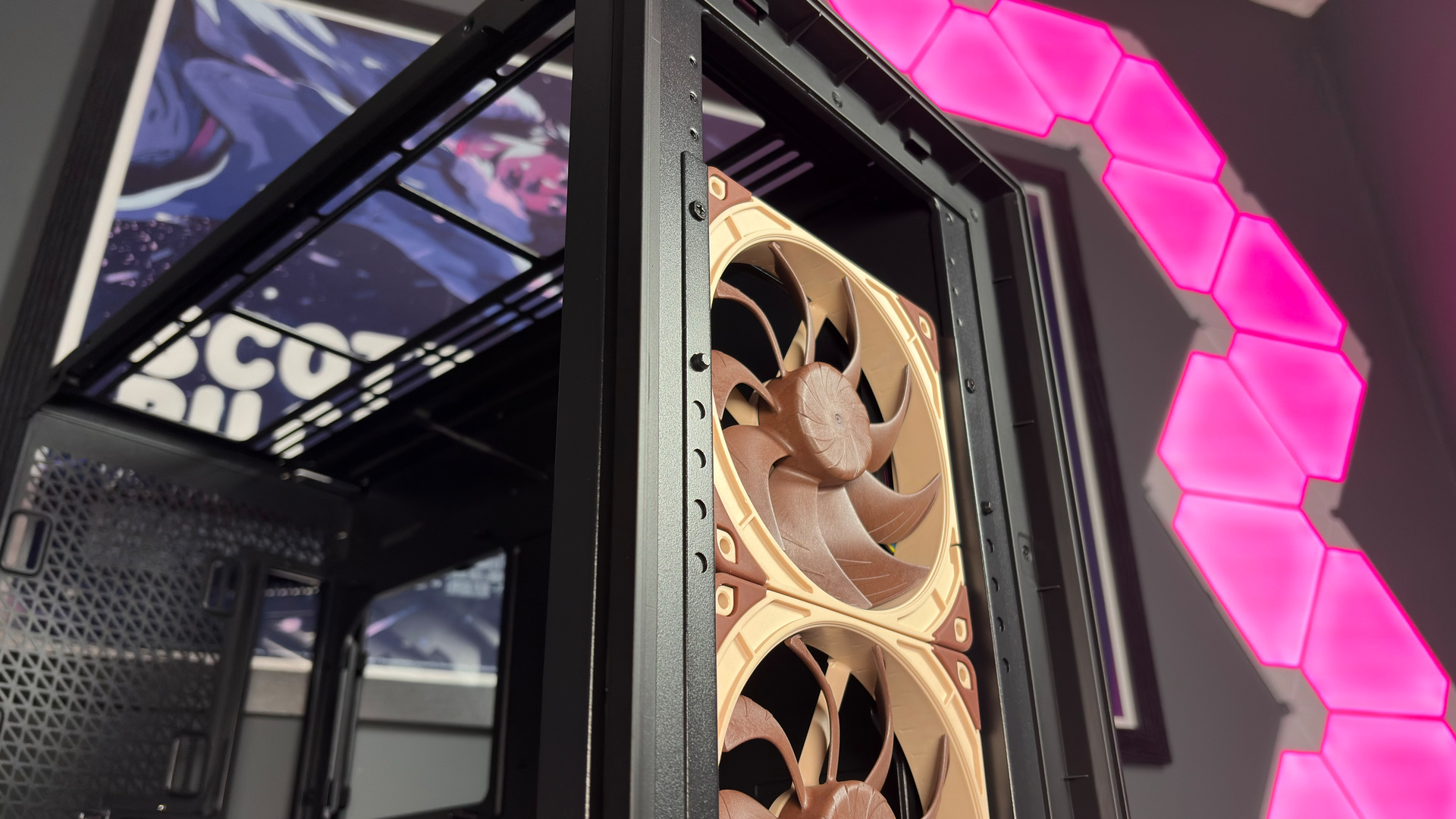 The Antec Flux Pro Noctua Edition on a desk with various parts disassembled.