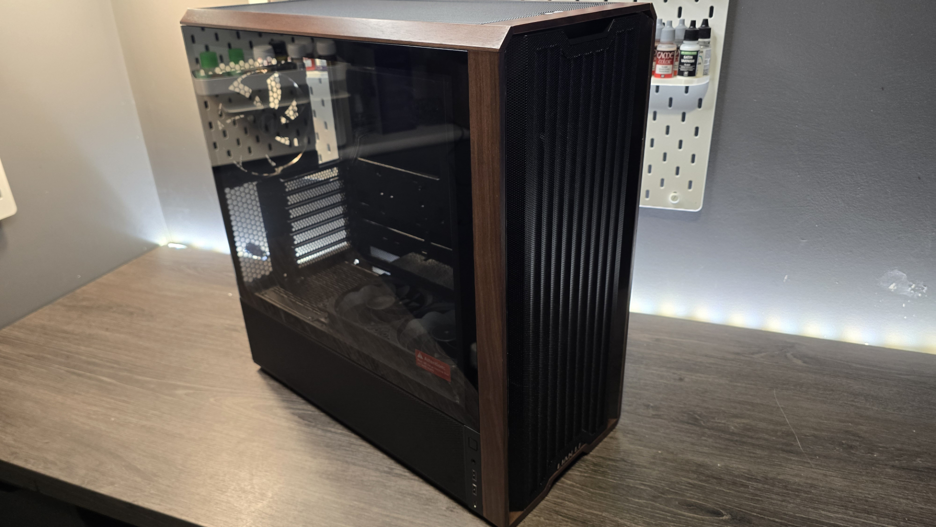 A Lian Li Lancool 217 on a desk with various components installed inside it.