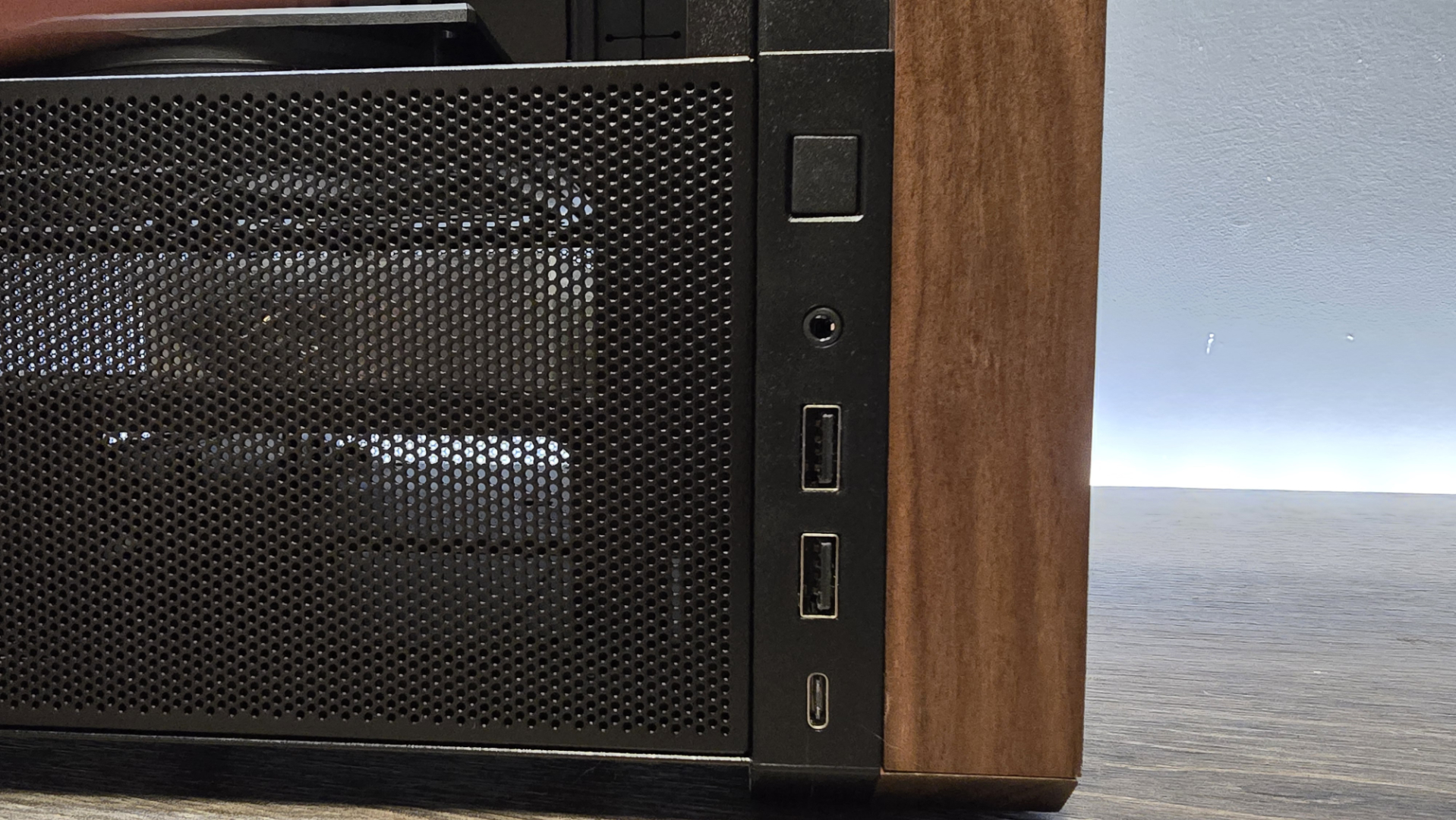 A Lian Li Lancool 217 on a desk with various components installed inside it.