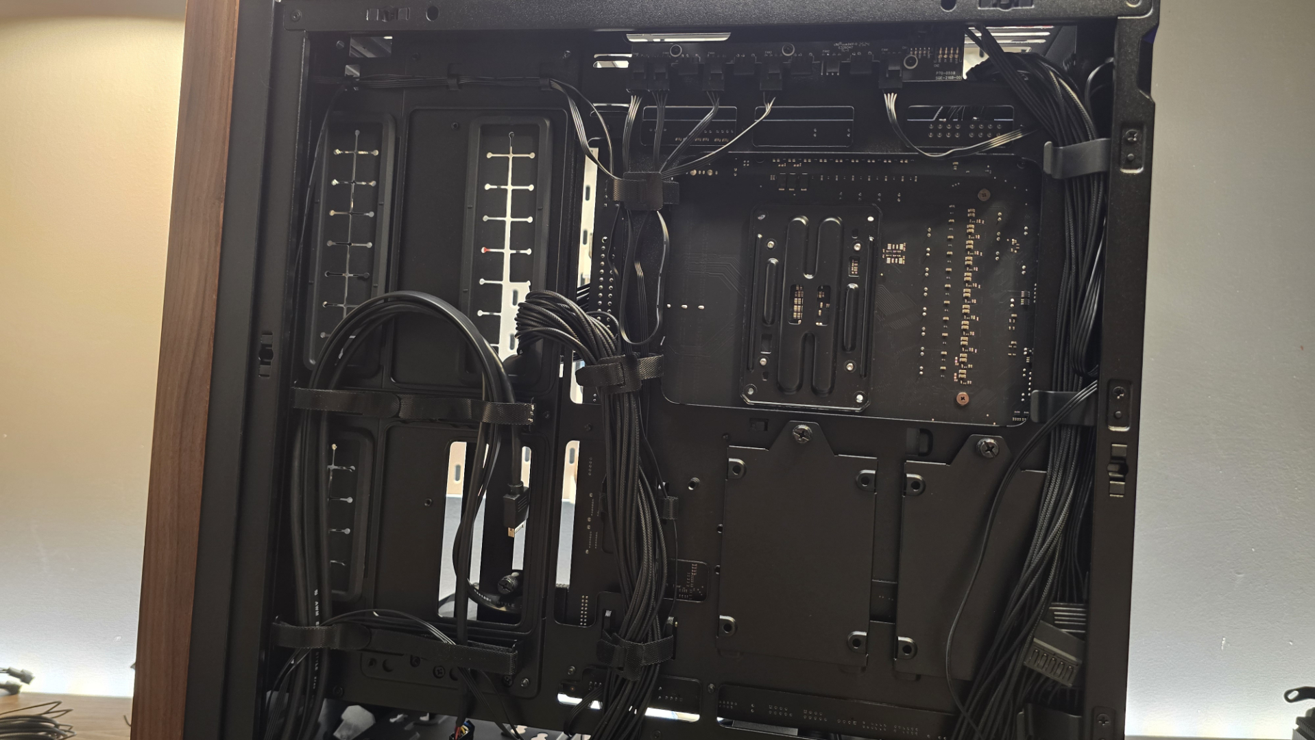 A Lian Li Lancool 217 on a desk with various components installed inside it.