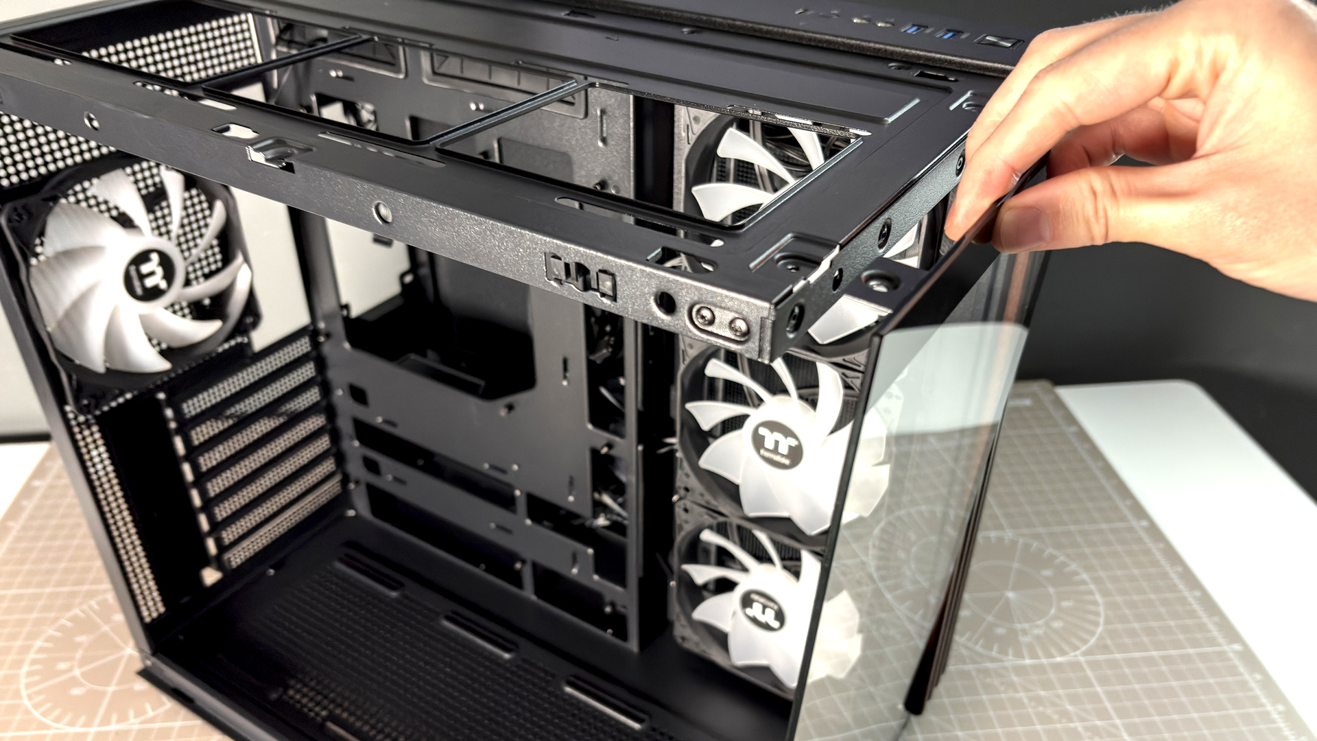 The Thermaltake View 380 WS ARGB on a desk with various components fitted.