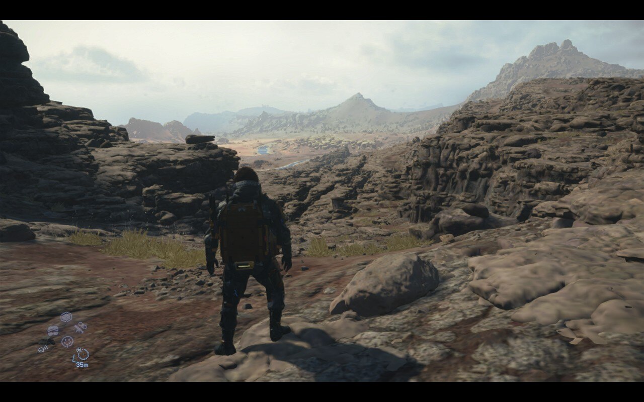 A man stands in a rocky environment with panoramic views