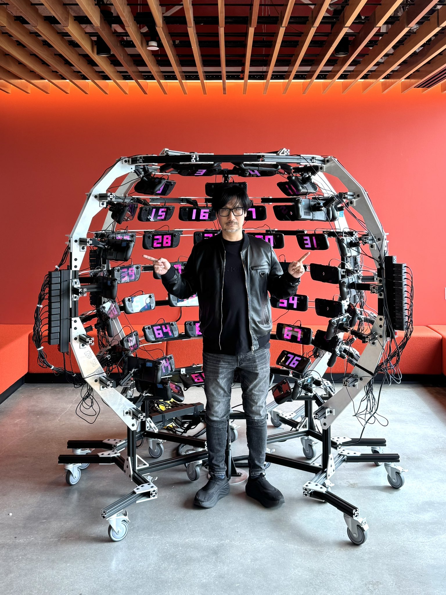 Hideo Kojima poses with various objects at Valve Software's offices.