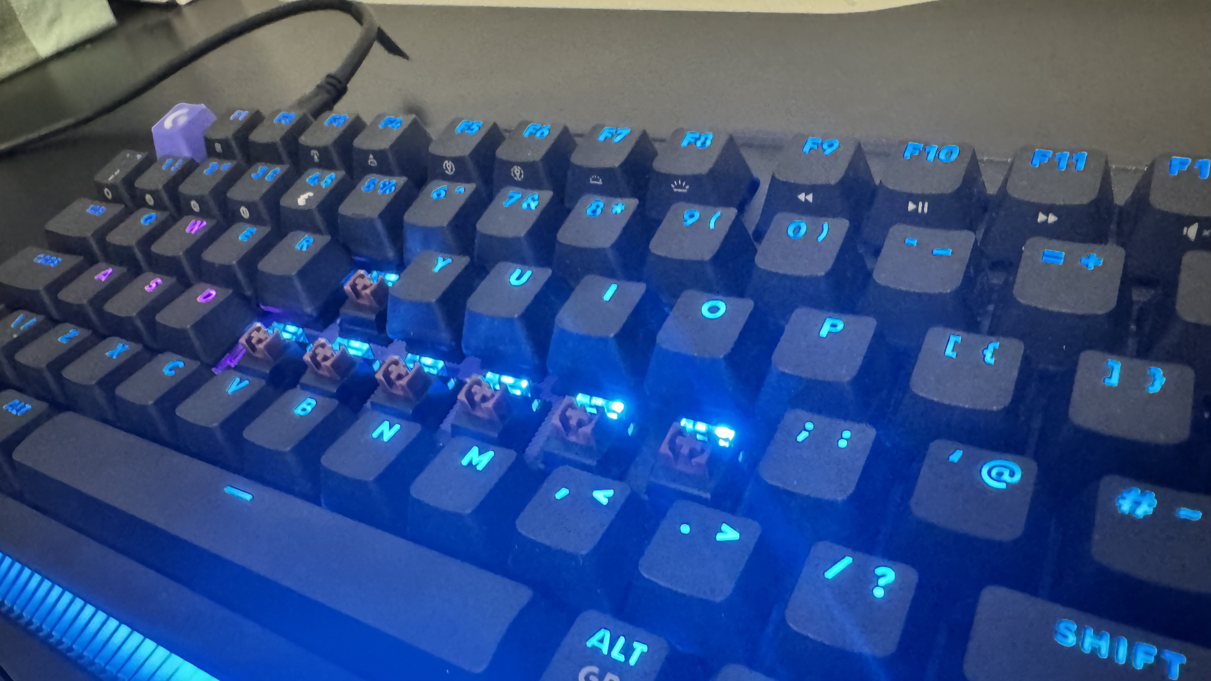 The Logitech G512 X gaming keyboard with RGB on without a handful of keycaps