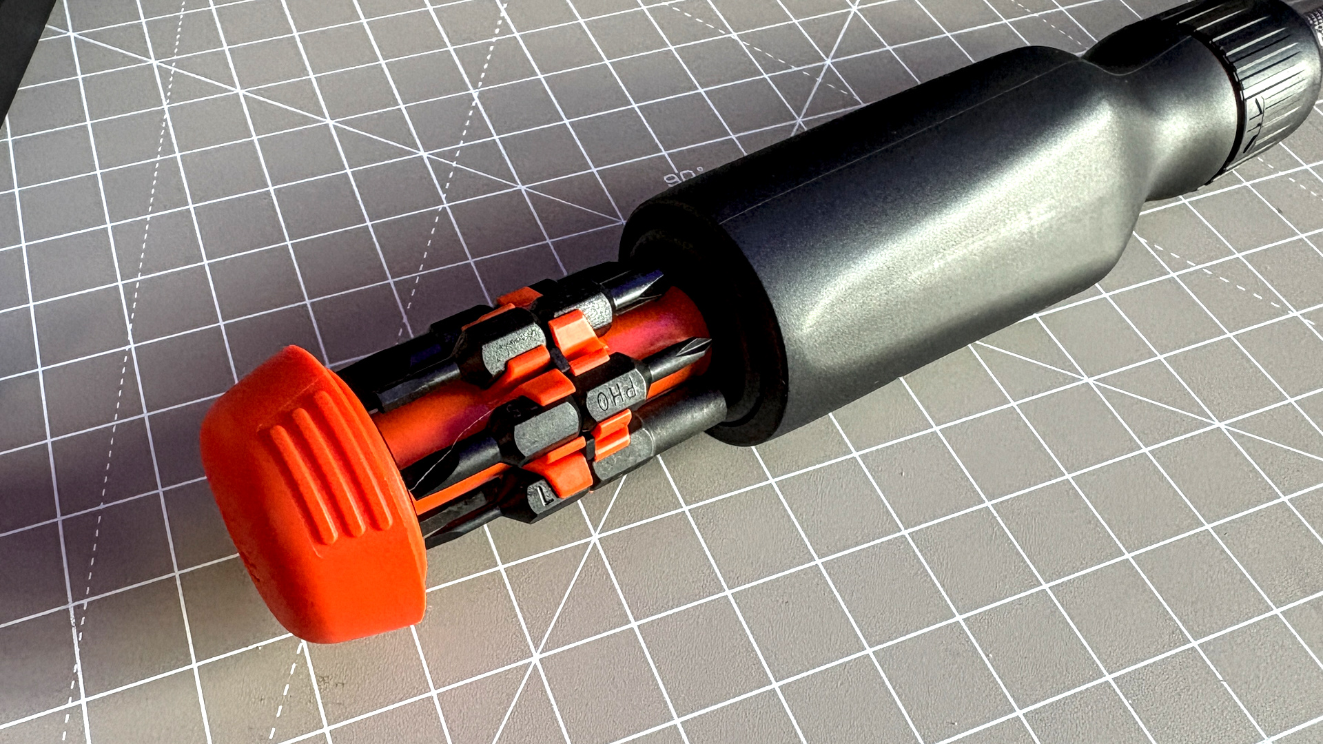 Two screwdrivers on a desk with orange highlights, sold by the YouTube channel Linus Tech Tips, or LTT for short.