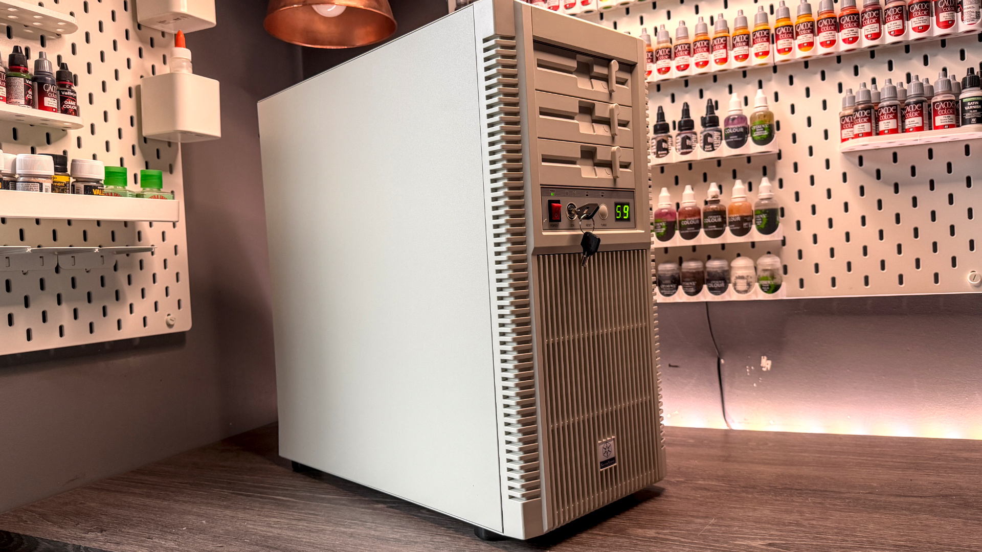 The retro-styled Silverstone FLP02 PC case as a PC is being built into it on a desk.