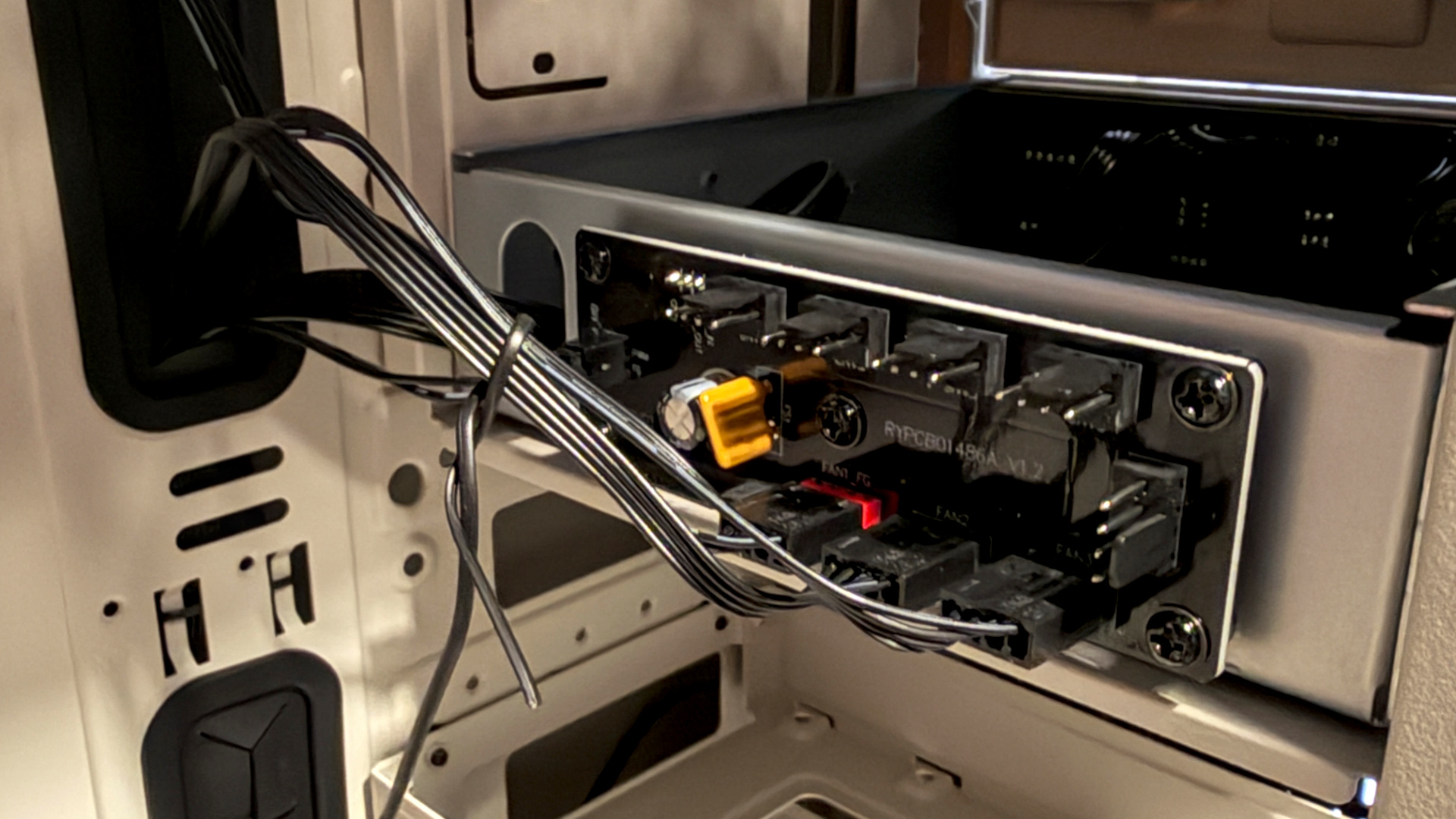 The retro-styled Silverstone FLP02 PC case as a PC is being built into it on a desk.