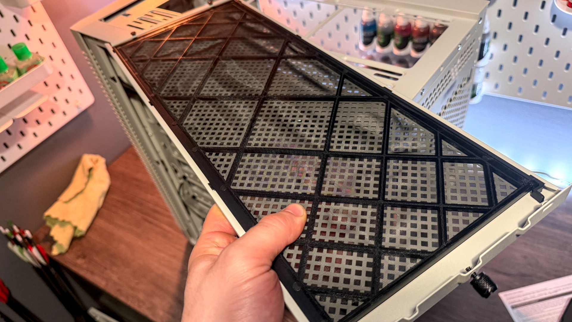 The retro-styled Silverstone FLP02 PC case as a PC is being built into it on a desk.