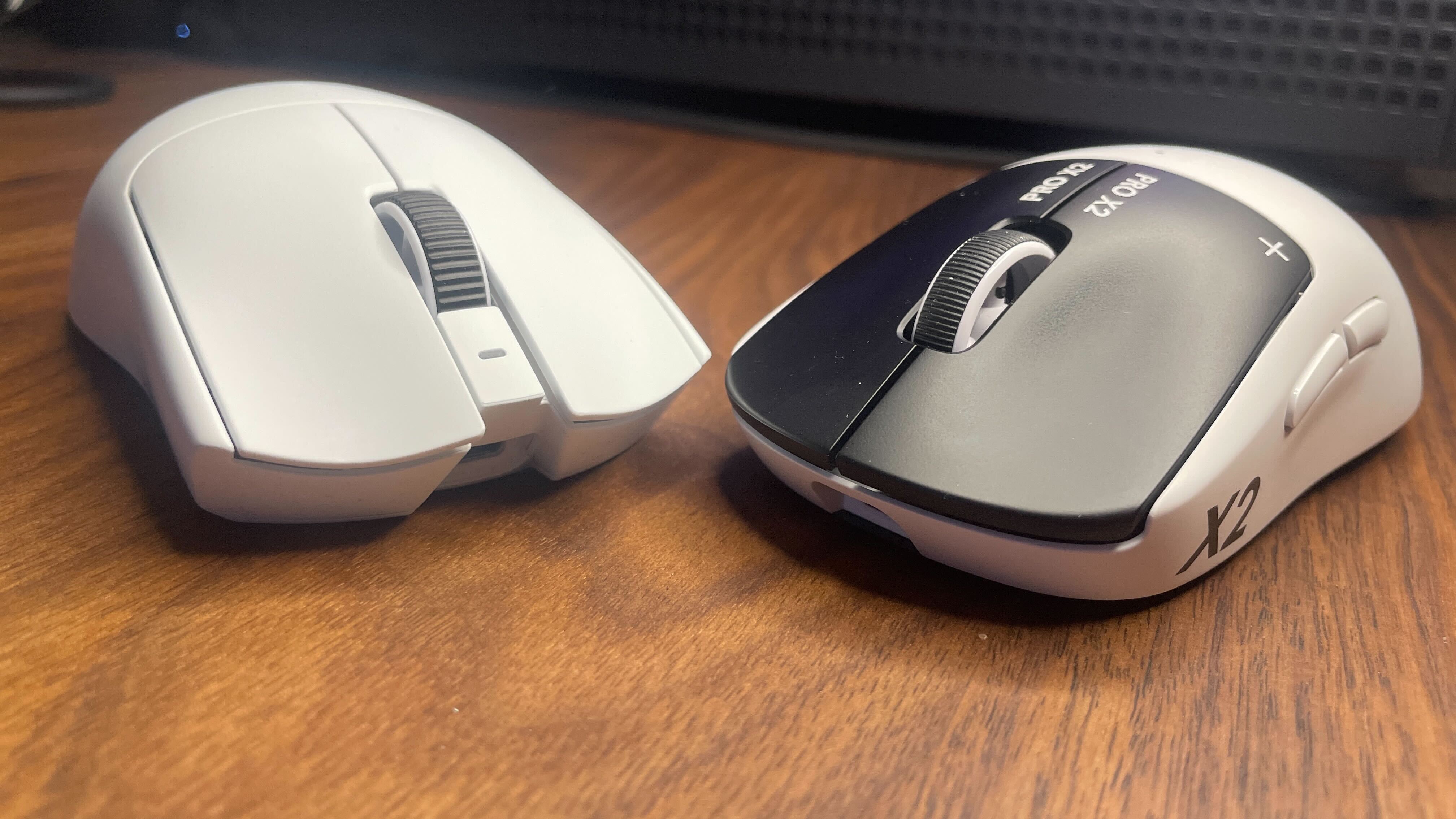 A Razer Viper V4 Pro next to a Logitech G Pro X2 Superstrike.
