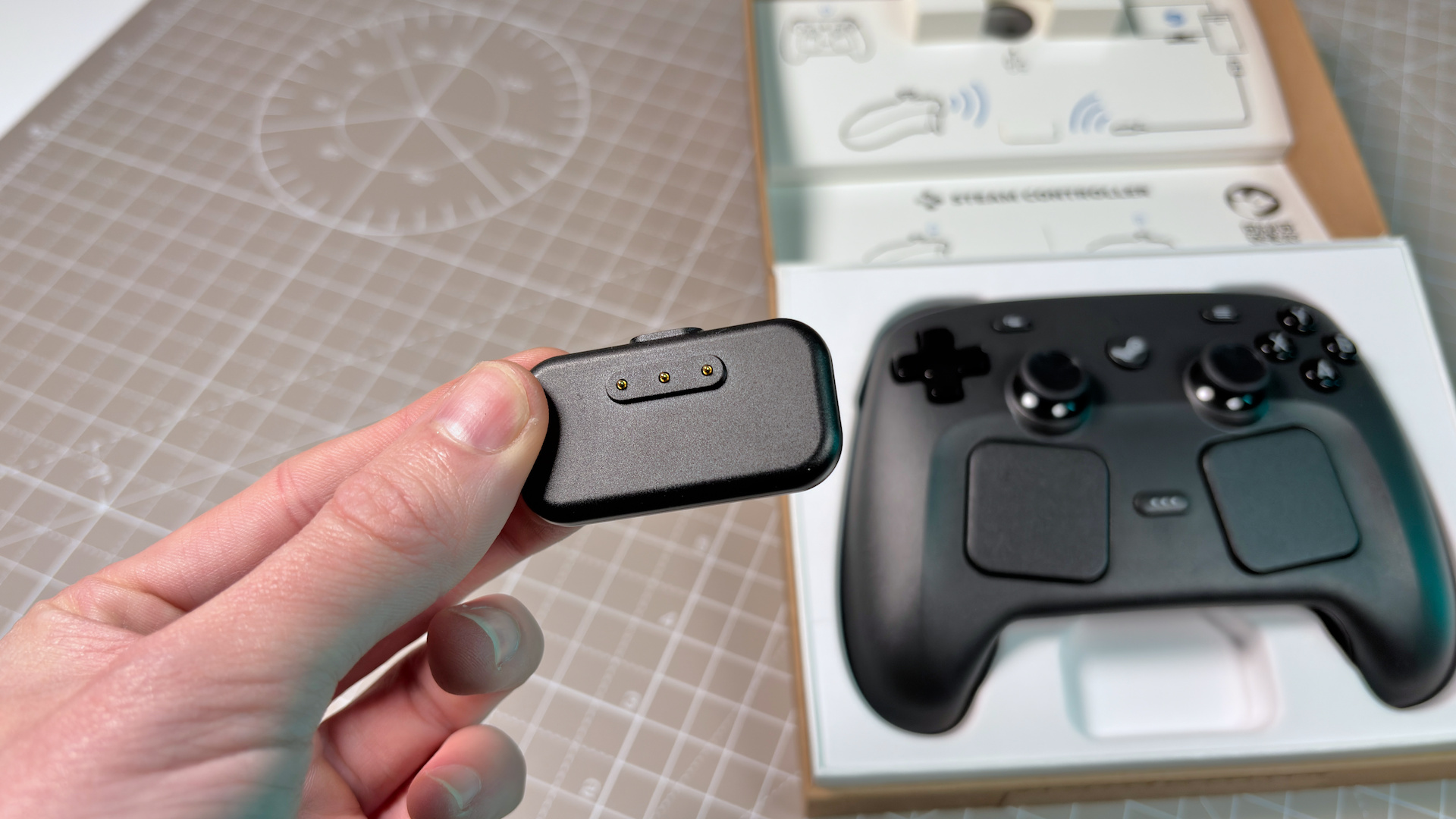 The Steam Controller on a desk during a teardown, with various parts removed.