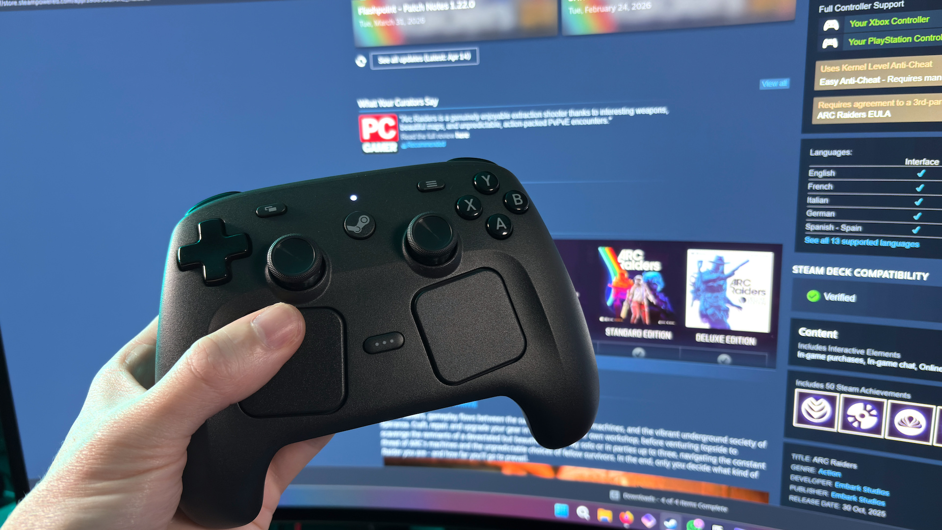 The Steam Controller on a desk during a teardown, with various parts removed.