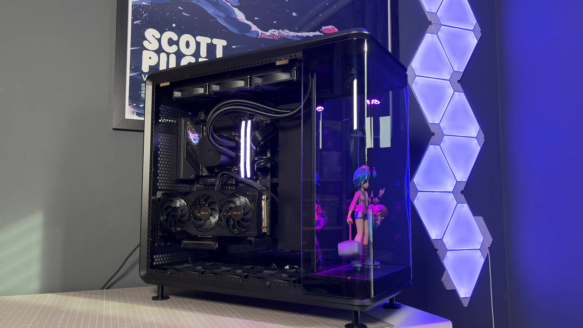 The CoolerMaster MasterFrame 360 Panoramic PC case with various components installed on a desk.