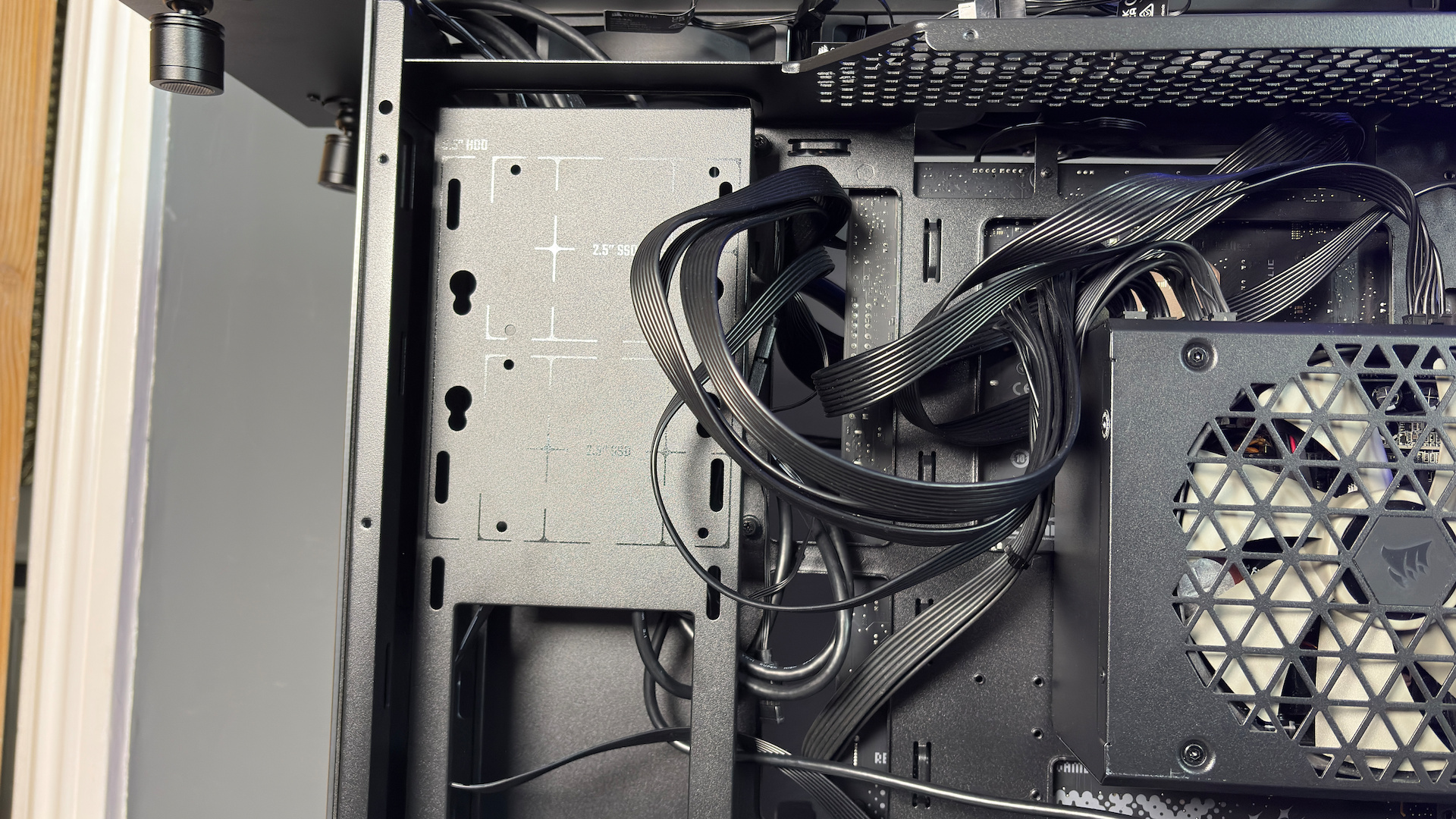 The CoolerMaster MasterFrame 360 Panoramic PC case with various components installed on a desk.