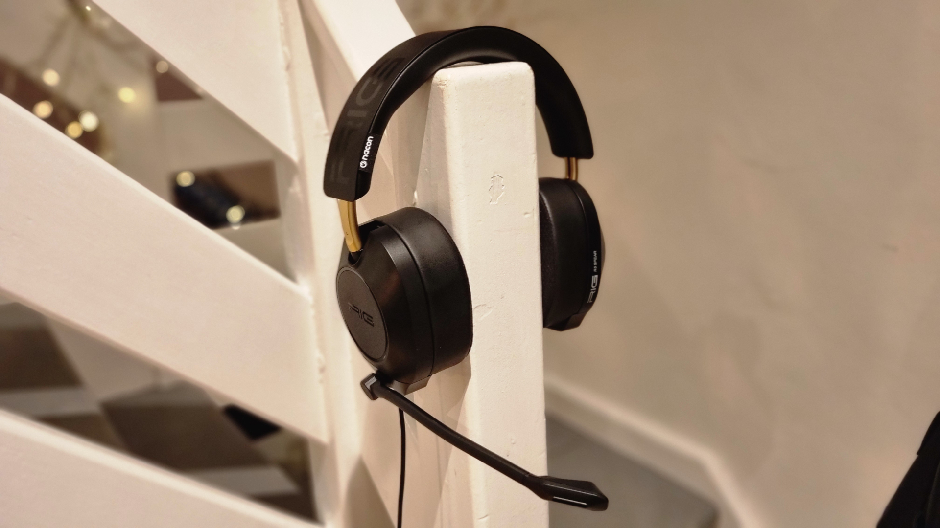A Rig R5 Spear Max HD gaming headset on a stair banister, as if being worn