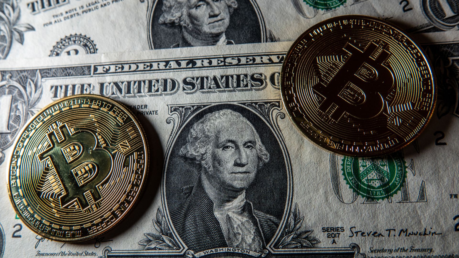 In this photo illustration a novelty Bitcoin token is photographed on a US Dollar bank note, on January 4, 2025 in Bath, England. The Cryptocurrency market has recently received a significant boost by the election of Donald Trump with hopes of the start of a policy framework that could see Bitcoin as a strategic asset