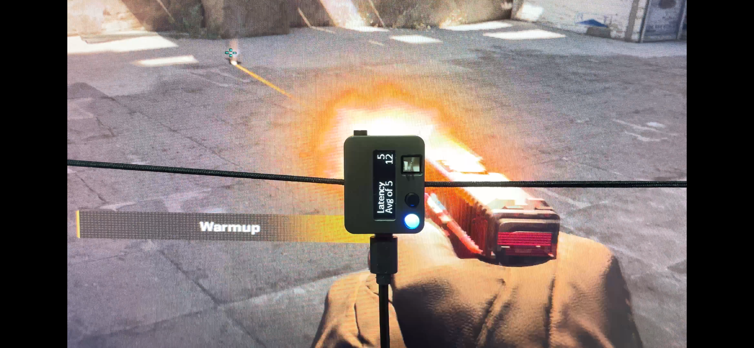 An Nvidia LDAT testing end-to-end latency on top of a muzzle flash in Counter-Strike 2.