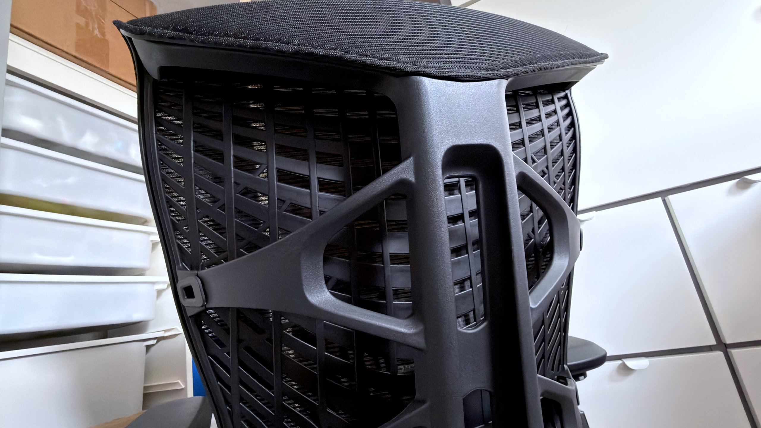 A photo of an Autonomous ErgoChair Ultra 2, showing a view of the rear spine and polymer mesh used in the back