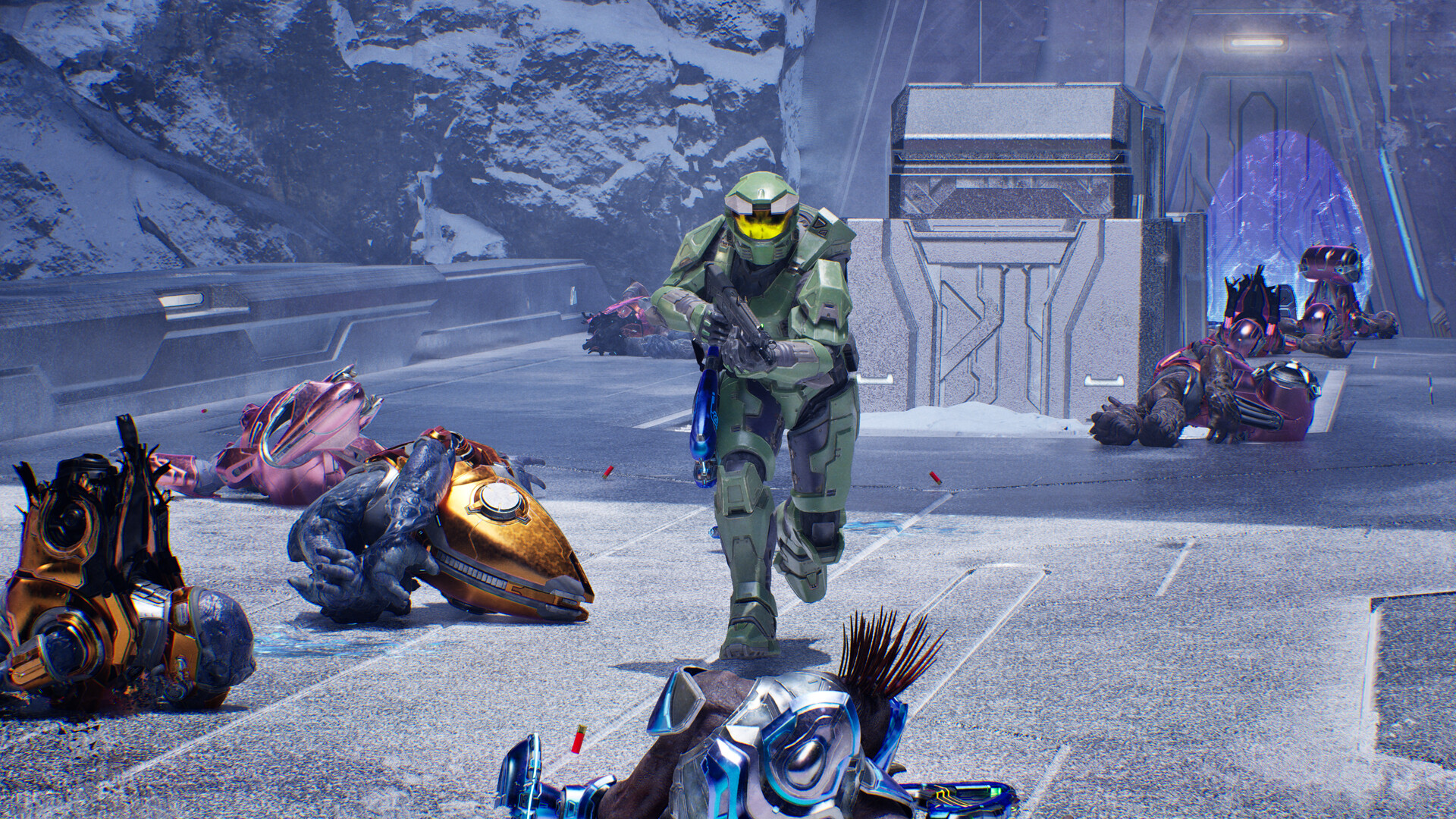 Halo Campaign Evolved: Master Chief running towards the camera with various dead Covenant on the ground.