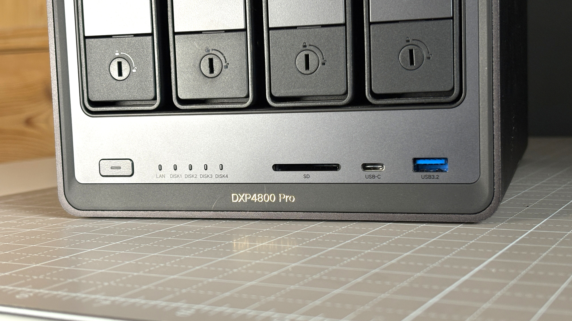 UGreen NASync DXP4800 Pro on a desk with multiple HDDs installed.