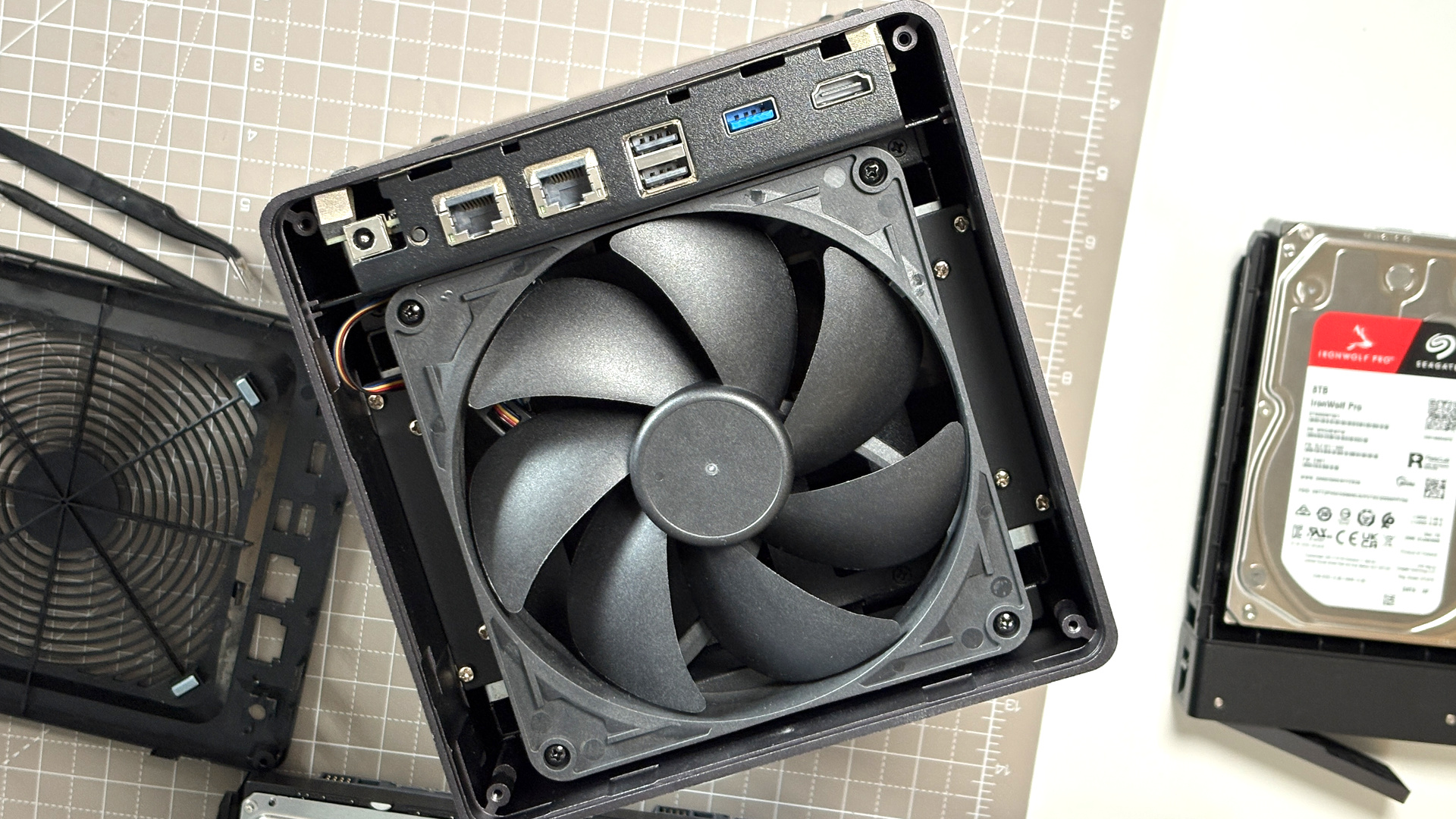 UGreen NASync DXP4800 Pro on a desk with multiple HDDs installed.