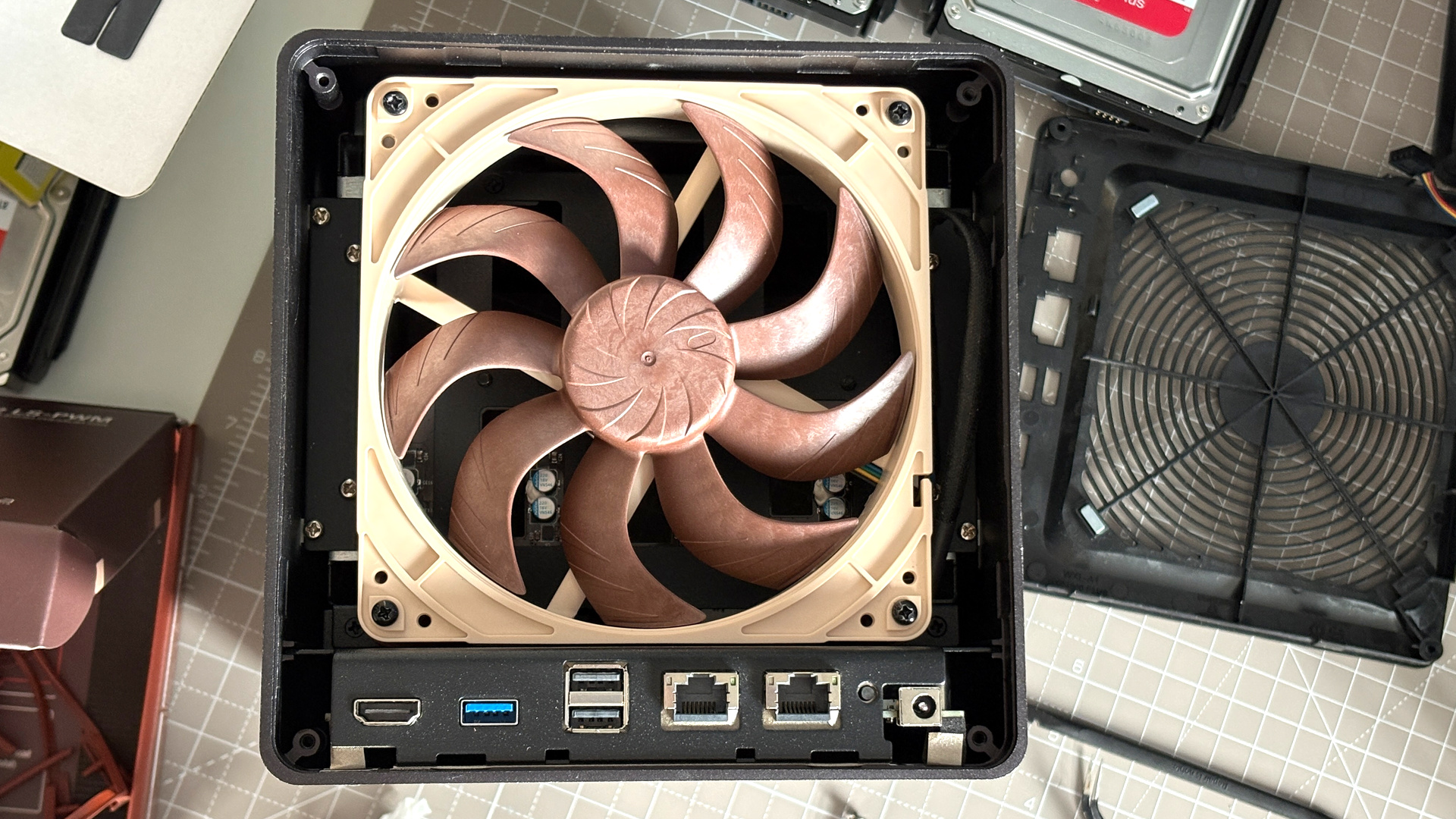 UGreen NASync DXP4800 Pro on a desk with multiple HDDs installed.
